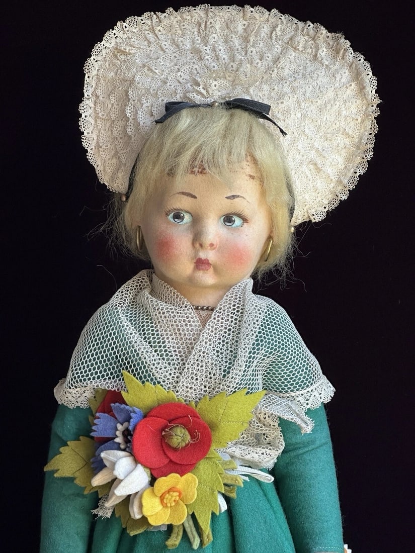 Vintage Italian Lenci 19" Felt Doll in Regional Torino Costume with Tags: This beauty is probably circa 40’s. She is nicely preserved and overall clean. She has light paint wear. Glue residue on the top front part of the head. She is all original. Her outfit shows light w