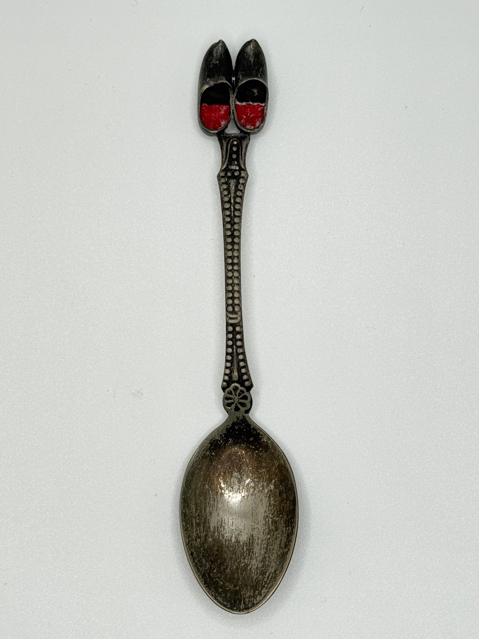 ELWEZETTA Silver Plate - Silver Plate Collector Spoon – Red Dutch Clogs (025 white): (025 white)Charming vintage collector spoon marked 'Zwiezeta Silver Plate,' topped with a pair of red enameled Dutch clogs. Ornate handle with raised bead detailing and floral accent near bowl. Weighs