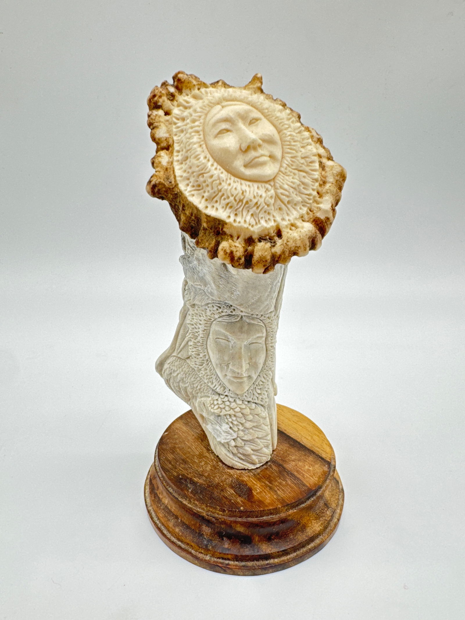 Inuit-Inspired Spirit Totem Carving – Animals & Shamanic Faces on Antler with Wood Base (069: This captivating totem-style sculpture features multiple hand-carved animal spirits—including an eagle, bear, moose, and wolf—encircling a serene human face evocative of Inuit shamanic art. Meticu