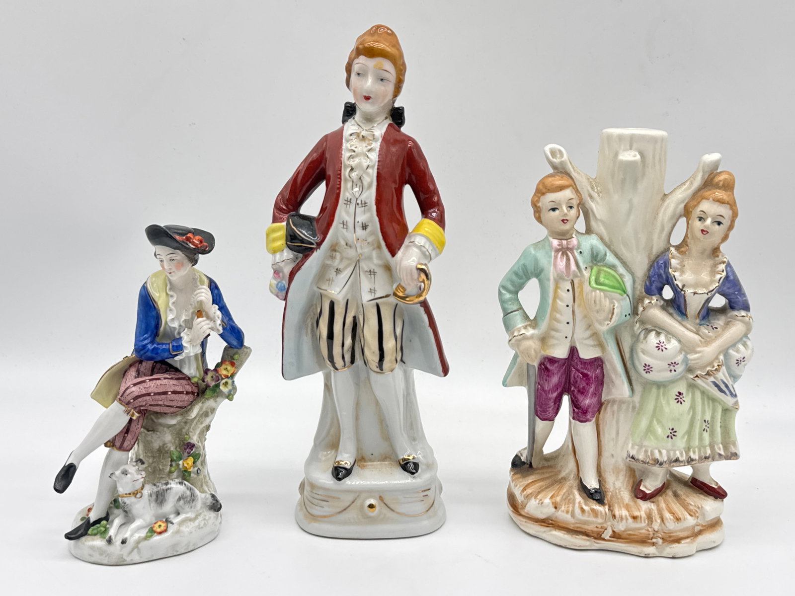 Vintage Colonial-Style Porcelain Figurines – Courting Couples & Aristocrat(153 white): Step into the elegance of the Rococo Revival with this charming trio of vintage porcelain figurines. Each figure features finely detailed attire reminiscent of 18th-century fashion, from powdered wigs