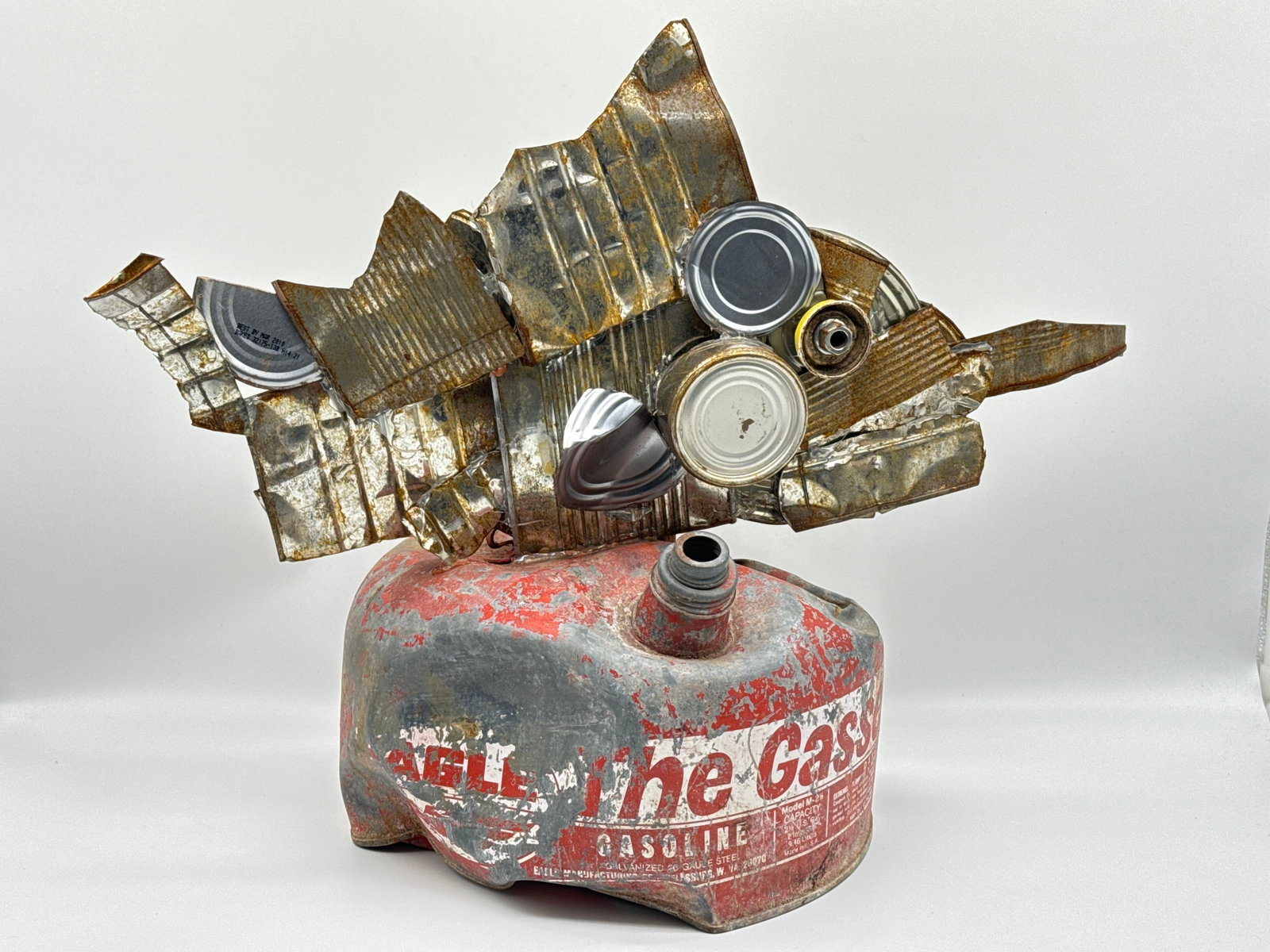 Chris Spollen Steampunk Found Object Sculpture – “The Gas Fish” RARE - 198 white: A brilliant example of Chris Spollen’s industrial storytelling, this whimsical steampunk sculpture titled “The Gas Fish” transforms discarded metal, gears, and a weathered gas can into an im