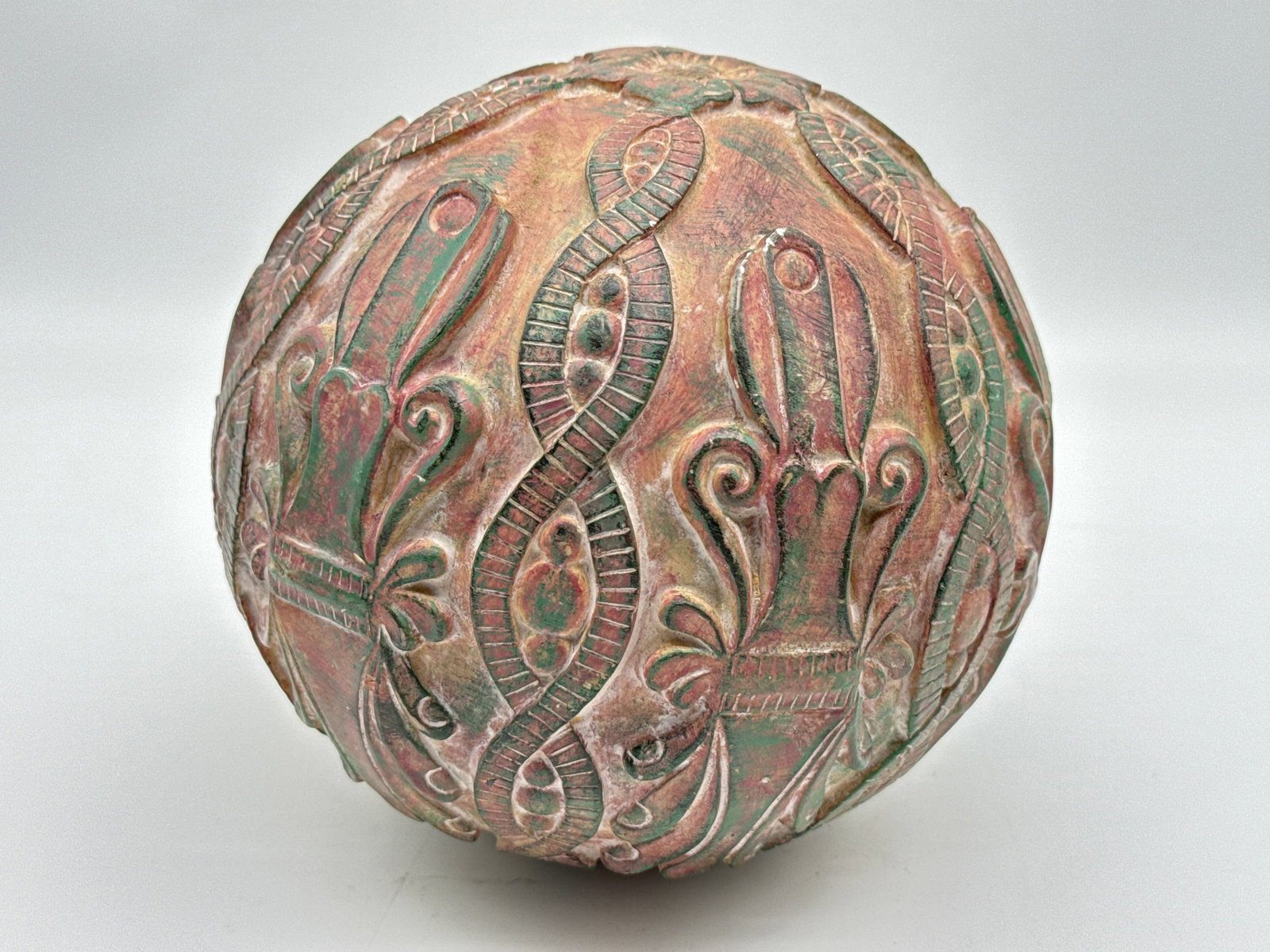 Decorative Carved Ceramic Sphere – Repeating Pattern Design with Earthy Glaze (014 orange): Bring texture and intrigue to your decor with this hand-carved ceramic sphere, featuring a repeating pattern of stylized floral and scroll motifs encircling the entire surface. The design includes rib