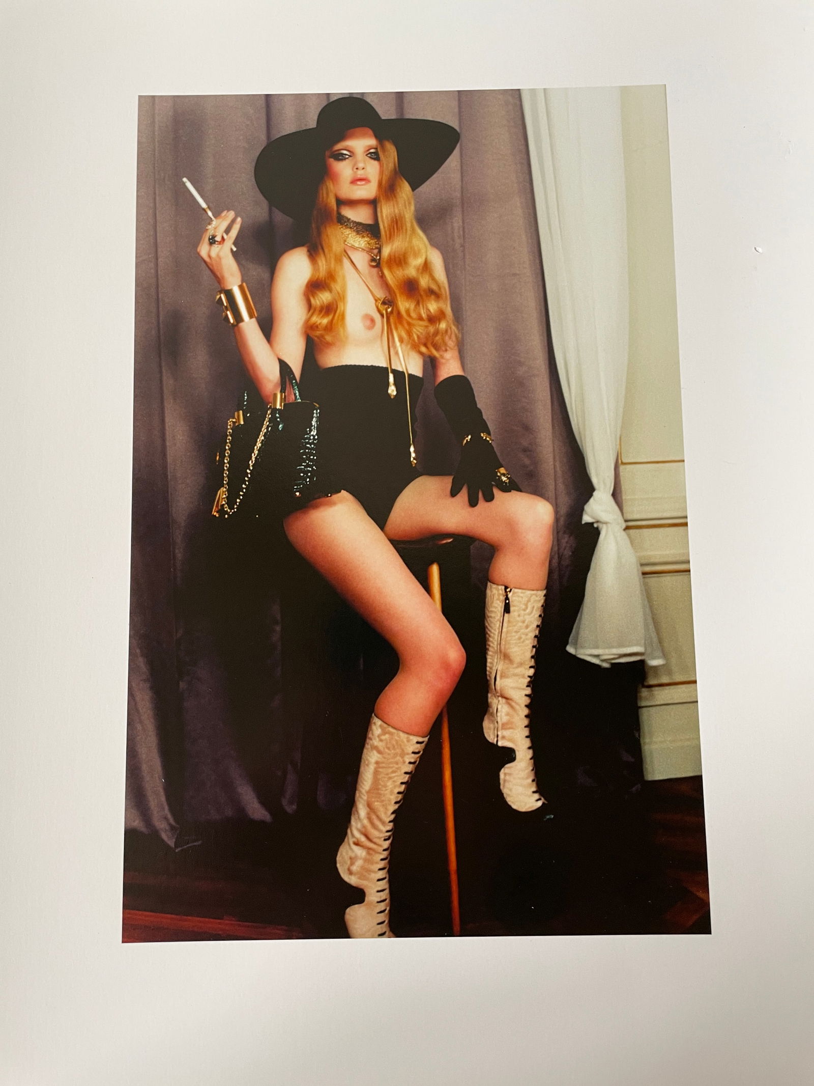 Irina Ionesco (1930–2022) – Woman with a Black Hat, High Boots, and Gloves. Color photograph: Irina Ionesco (1930–2022) – Woman with a Black Hat, High Boots, and Gloves. Color photograph depicting a woman in a provocative pose, wearing cream-colored laced boots, black gloves, gold jewelry,
