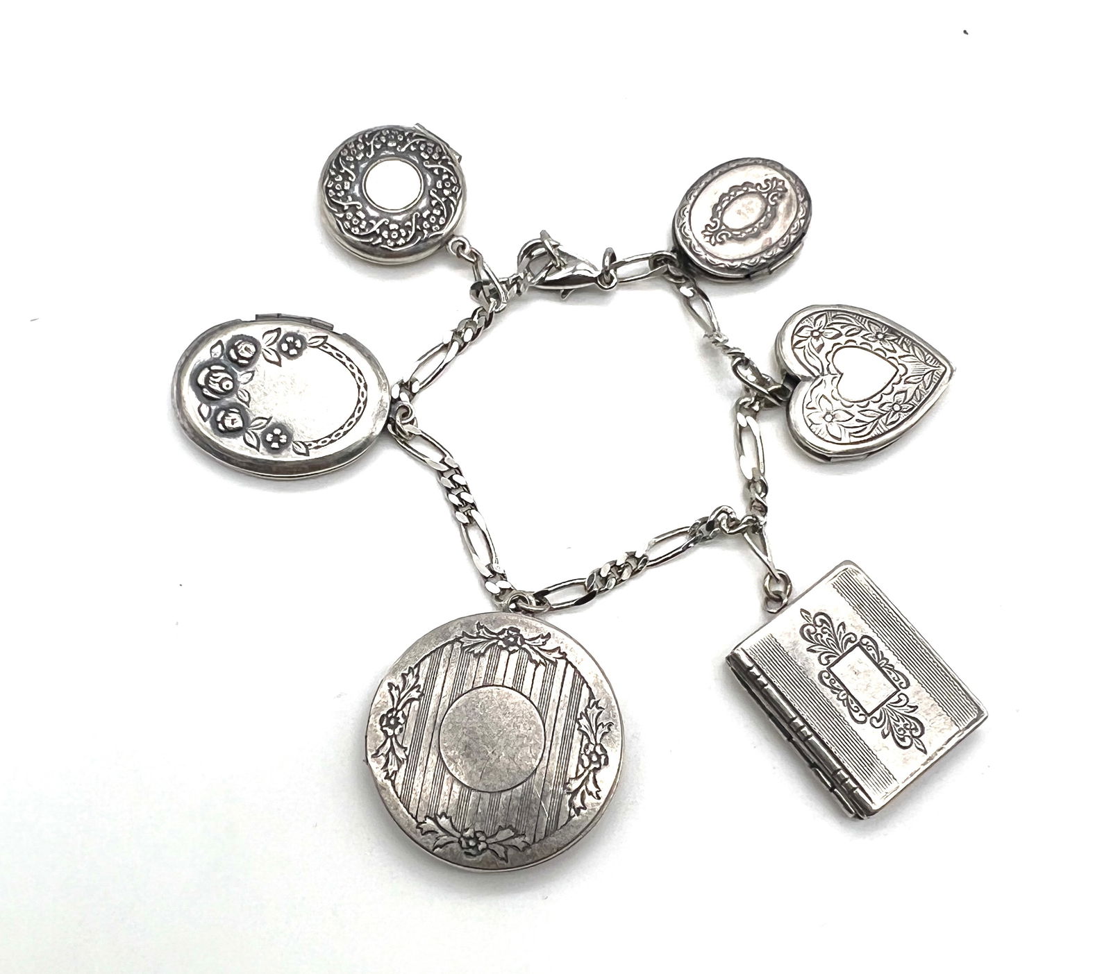 Vintage Sterling Silver Charm Bracelet with Heart, Book, and Locket Charms: Bid now on this exquisite vintage sterling silver charm bracelet, a timeless piece brimming with sentimental charm and craftsmanship. Featuring a delicate chain adorned with five intricately detailed