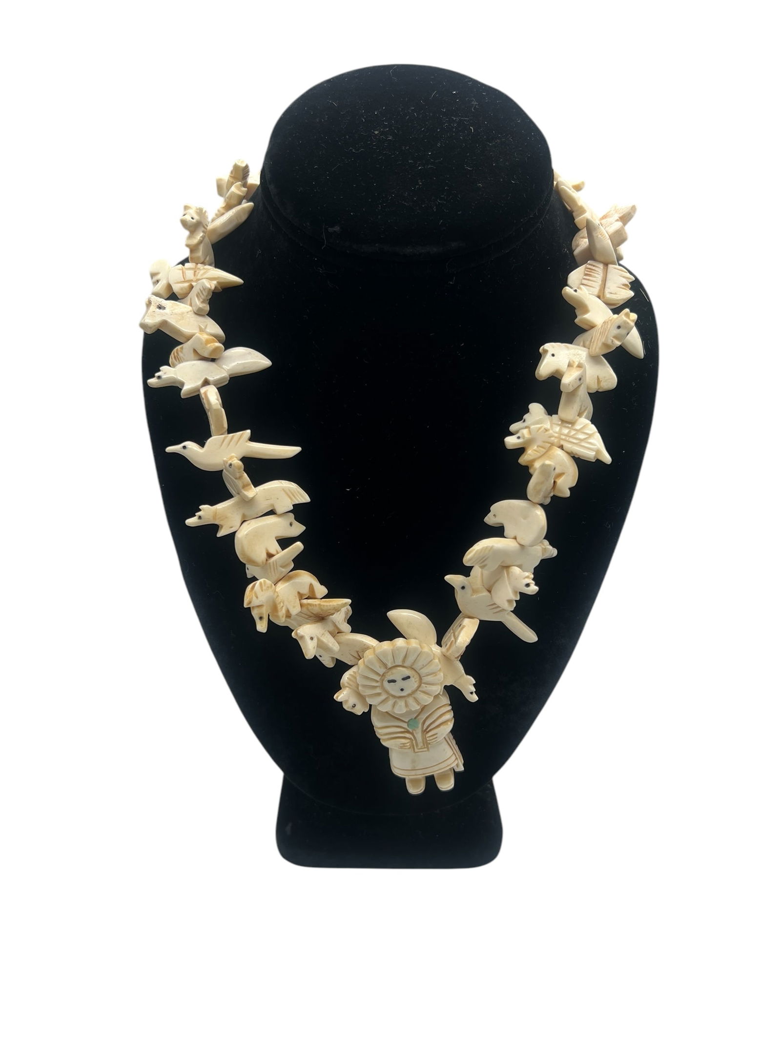 Authentic Zuni Fetish Necklace with Carved Bone Animals and Turquoise Inlay Pendant: Discover a stunning piece of Native American artistry with this authentic Zuni fetish necklace, a masterful creation from the Zuni Pueblo. Handcrafted with meticulous detail, the necklace features doz