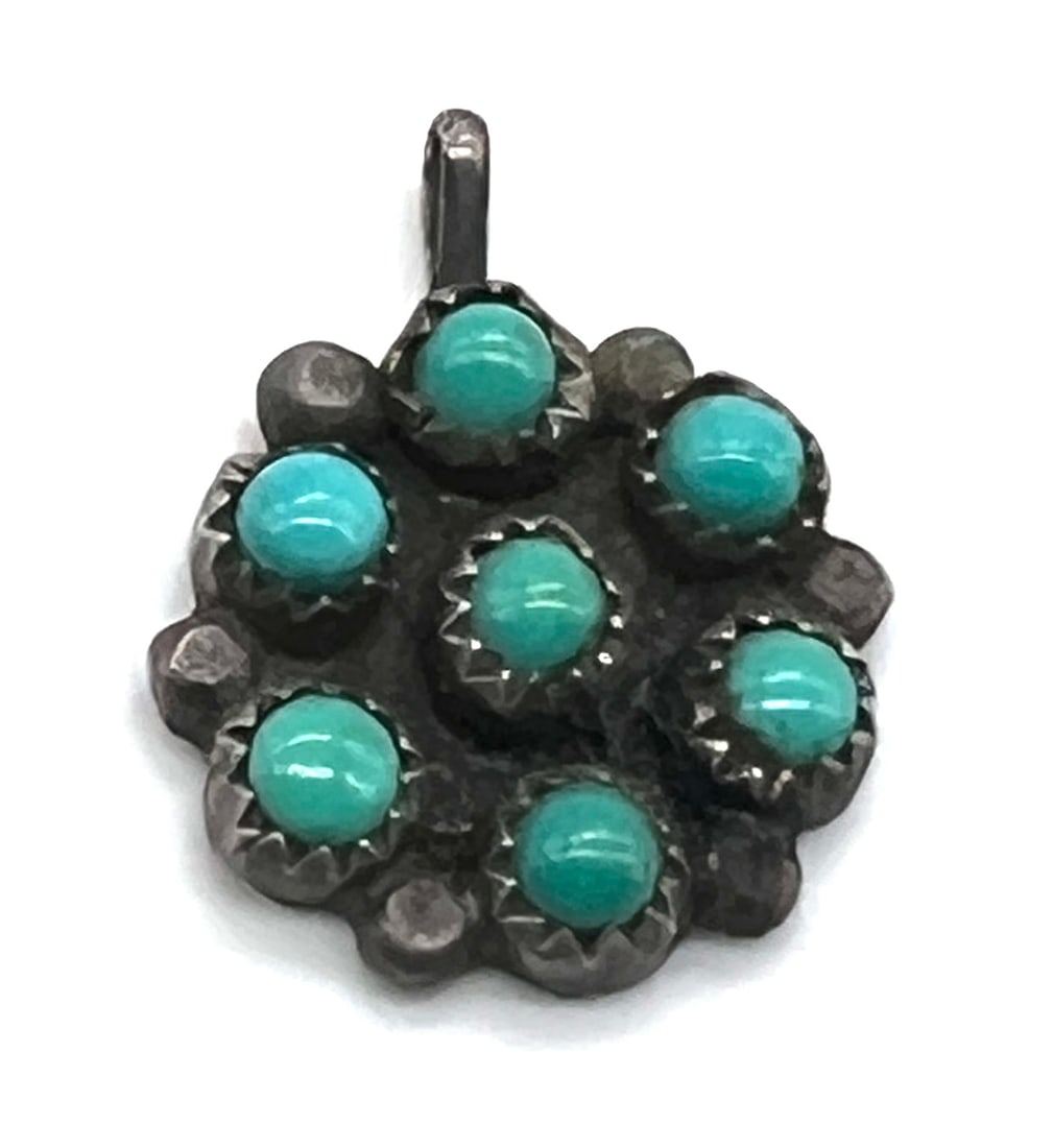 Vintage Navajo Turquoise Cluster Pendant in Oxidized Sterling Silver: Discover a stunning vintage Navajo turquoise cluster pendant, a true testament to Southwestern artistry. Crafted in oxidized sterling silver, this circular pendant features a vibrant array of genuine 