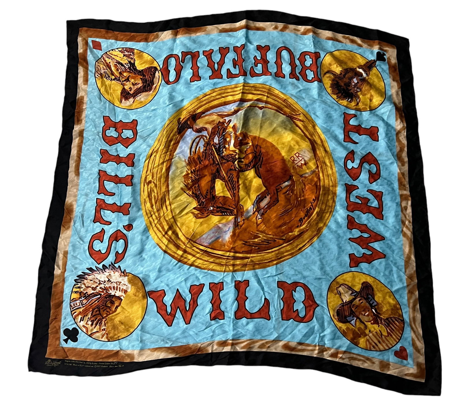 Buffalo Bill's Wild West Silk Scarf: Buffalo Bill's Wild West Silk Scarf, featuring a central graphic depicting a cowboy and bear in a circular frame, surrounded by vignettes of Native American figures and western imagery, with bold lett