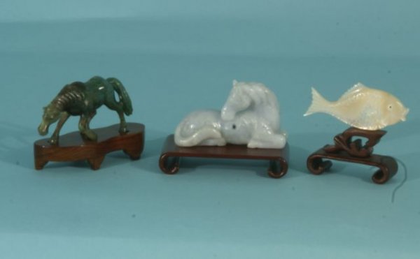 TWO JADE HORSES AND ONE CARVED ABALONE FISH: TWO JADE HORSES AND ONE CARVED ABALONE FISH. Height: 3 1/2 and 2 3/4 and 2 1/4 in. by Width: 3 1/2 and 3 1/2 and 4 in. by Depth: 1/2 and 1 1/2 and 1 in.