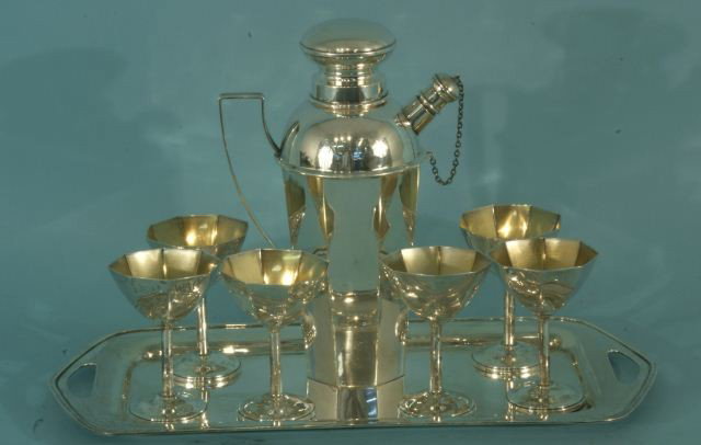STERLING SILVER MARTINI SET WITH SIX GLASSES: STERLING SILVER MARTINI SET & SHAKER WITH SIX GLASSES & TRAY. Height: 10 in. by Width: 7 in. by Depth: 5 in.