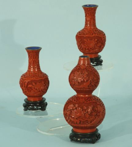 THREE ORIENTAL CARVED CINNABAR VASES WITH STANDS: THREE ORIENTAL CARVED CINNABAR VASES WITH STANDS. Height: 9 in. by Width: 4 1/2 in. in. by Depth: 4 1/2 in.