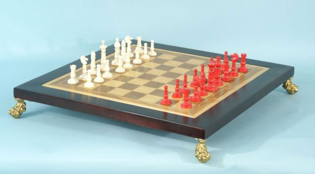MAHOGANY AND FRUITWOOD INLAID CHESS SET: MAHOGANY AND FRUITWOOD INLAID CHESS SET BOARD WITH CARVED IVORY CHESS PIECES. Height: 7 in. by Width: 22 1/2 in. by Depth: 22 1/2 in.