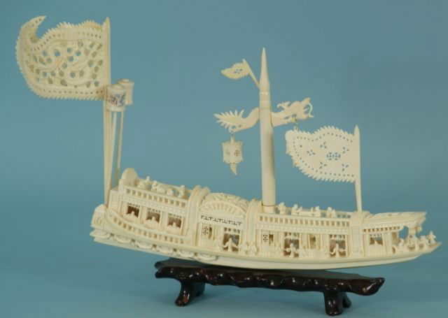 ELABORATELY CARVED GENUINE IVORY "JUNK": ELABORATELY HAND CARVED GENUINE IVORY "JUNK". TWO DRAGON HEADS AT THE STERN, ELABORATELY CARVED AND PIERCED, WELL CARVED SAILS AND MAST. Height: 10 in. by Width: 15 in. by Depth: 2 1/4 in.