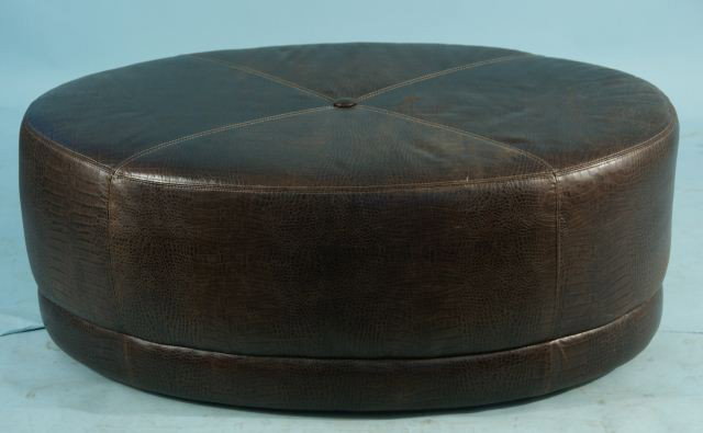 EMBOSSED FAUX ALLIGATOR OTTOMAN BY MASTER LEATHER: EMBOSSED FAUX ALLIGATOR OVAL LEATHER OTTOMAN ON CASTERS MADE BY MASTER LEATHER COMPANY. Height: 17 in. by Width: 44