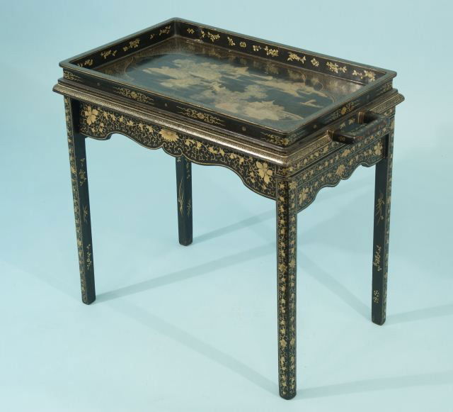 CHIA CH'ING PERIOD TEA TABLE, CIRCA 1796-1820: ANTIQUE CHINESE BLACK LACQUER FOLDING TEA TABLE WITH GOLD LACQUER DECORATION. THE TABLE TOP IS PAINTED WITH A CLASSIC TAOIST LANDSCAPE SURROUNDED BY INTERLOCKING KEY PATTERNS. THE LEGS AND APRONS ARE