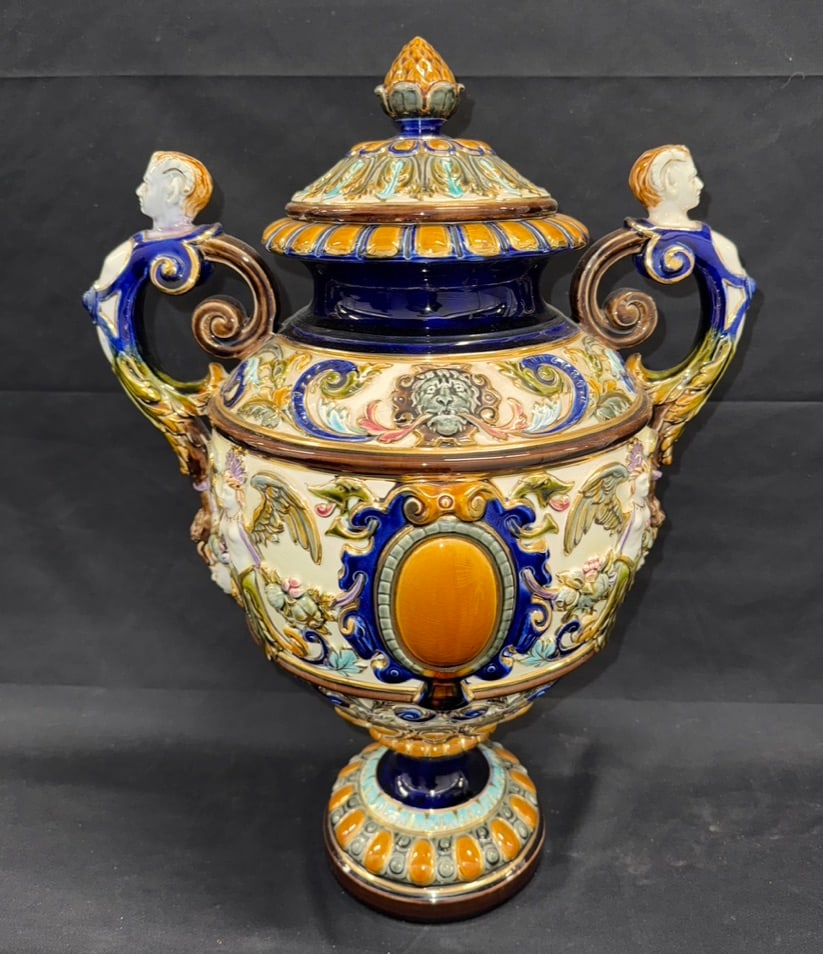 1900' Swedish Rörstrand Figural Double Handled Covered Majolica Urn With Angels, Medallions,: A large Rorstrand Majolica Pottery Covered Urn, from around 1900. Raised foliage, medallions, angelic figures and lion heads encircling the surface. Figural bust flanked on both the top and bottom of