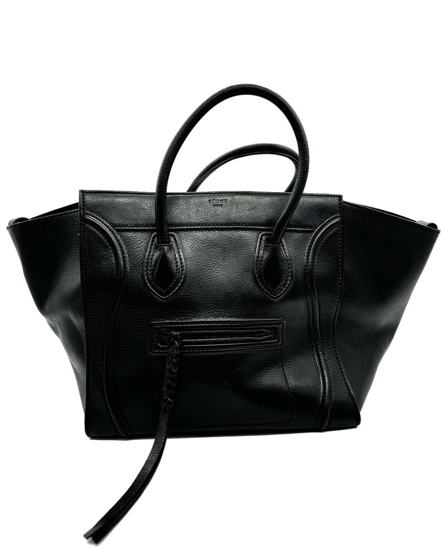 Celine Large Phantom Tote Black: Celine Large Phantom Tote Black This sophisticated tote is crafted of calfskin leather in black. This handbag features rolled leather top handles, an exterior zipper pocket, expandable sides, and the