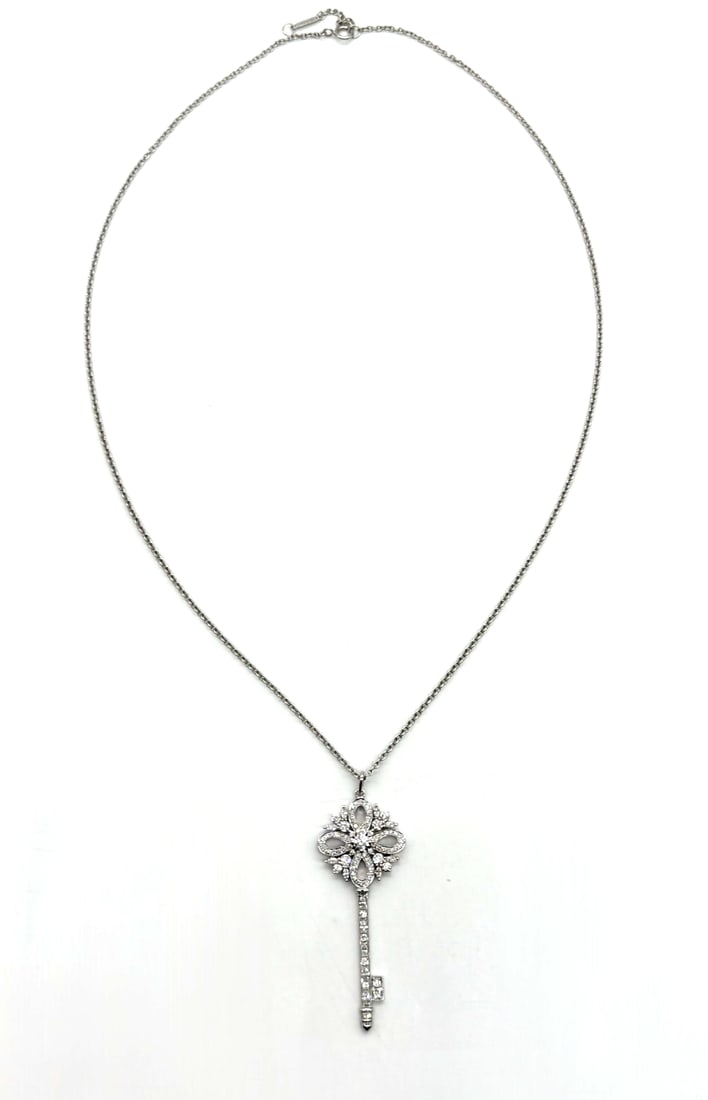 Tiffany & Co Victoria Large Diamond Key Pendant Necklace 18kt White Gold: Tiffany & Co Victoria Large Diamond Key Pendant Necklace 18kt White GoldThe Tiffany & Co Victoria Large Diamond Key Pendant Necklace in 18kt White Gold is a stunning piece of fine jewelry. The pendant