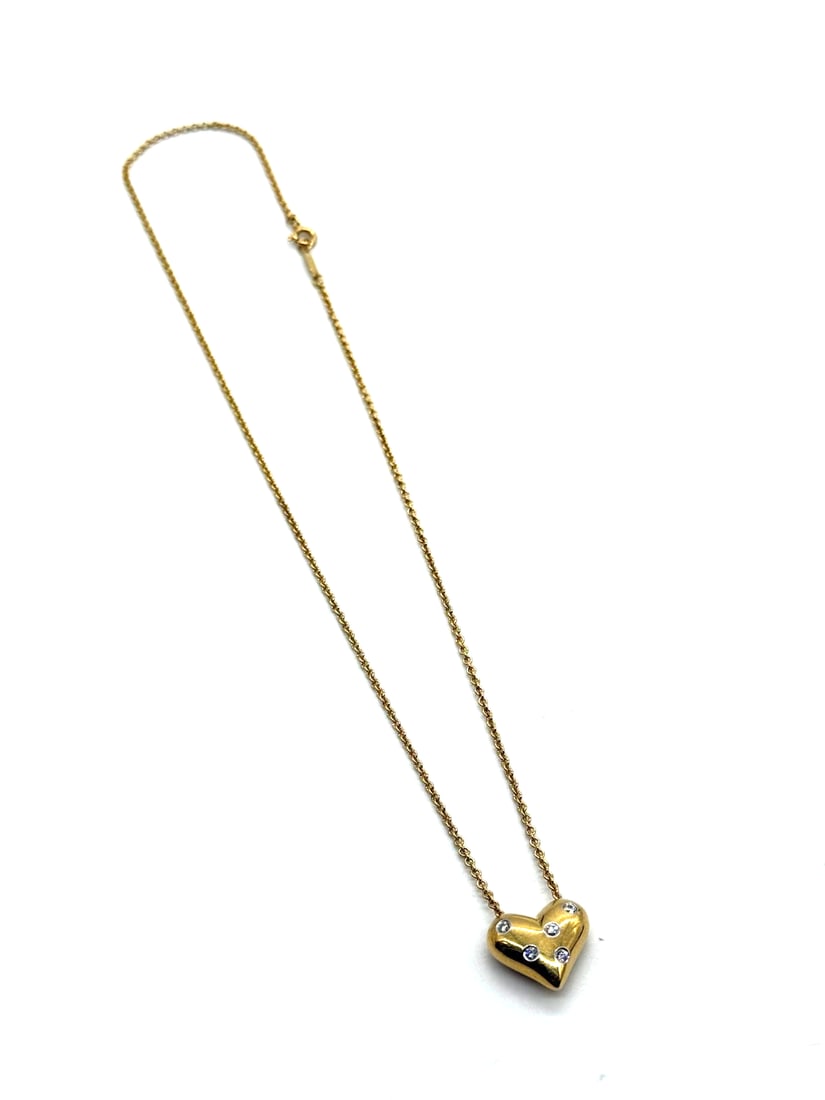 Vintage Tiffany & co. 0.15ct Diamond Platinum & 18K Yellow Gold Heart Necklace: This RARE Vintage Tiffany & Co. 0.15ct Diamond Platinum & 18K Yellow Gold Heart Necklace features a beautiful heart-shaped pendant with a yellow fancy diamond as the main stone. The necklace is crafte