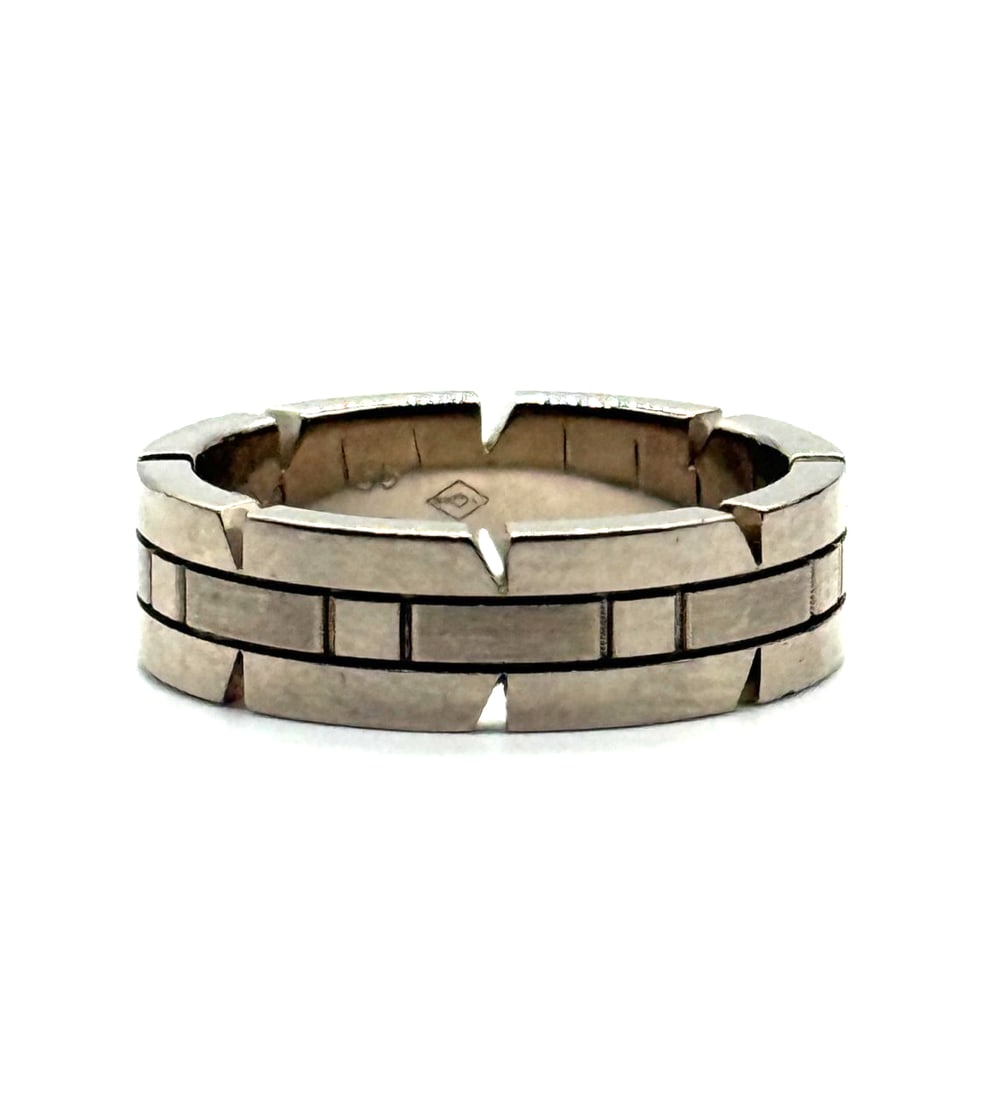 Cartier Tank Francaise Ring 18K White Gold: The Cartier Tank Francaise Ring in 18K White Gold is a luxurious and elegant piece of fine jewelry from the renowned brand Cartier. This ring features a sleek design with a white gold metal band, show