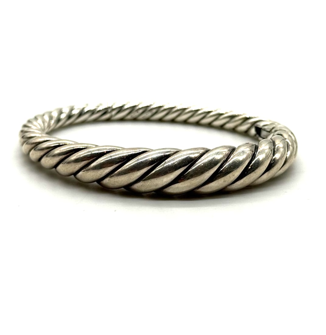David Yurman Sterling Silver Pure Form Cable Bracelet: The David Yurman Sterling Silver Pure Form Cable Bracelet is a timeless and elegant piece made from high-quality 925 sterling silver. With a sleek bangle style and a classic cable design, this bracele