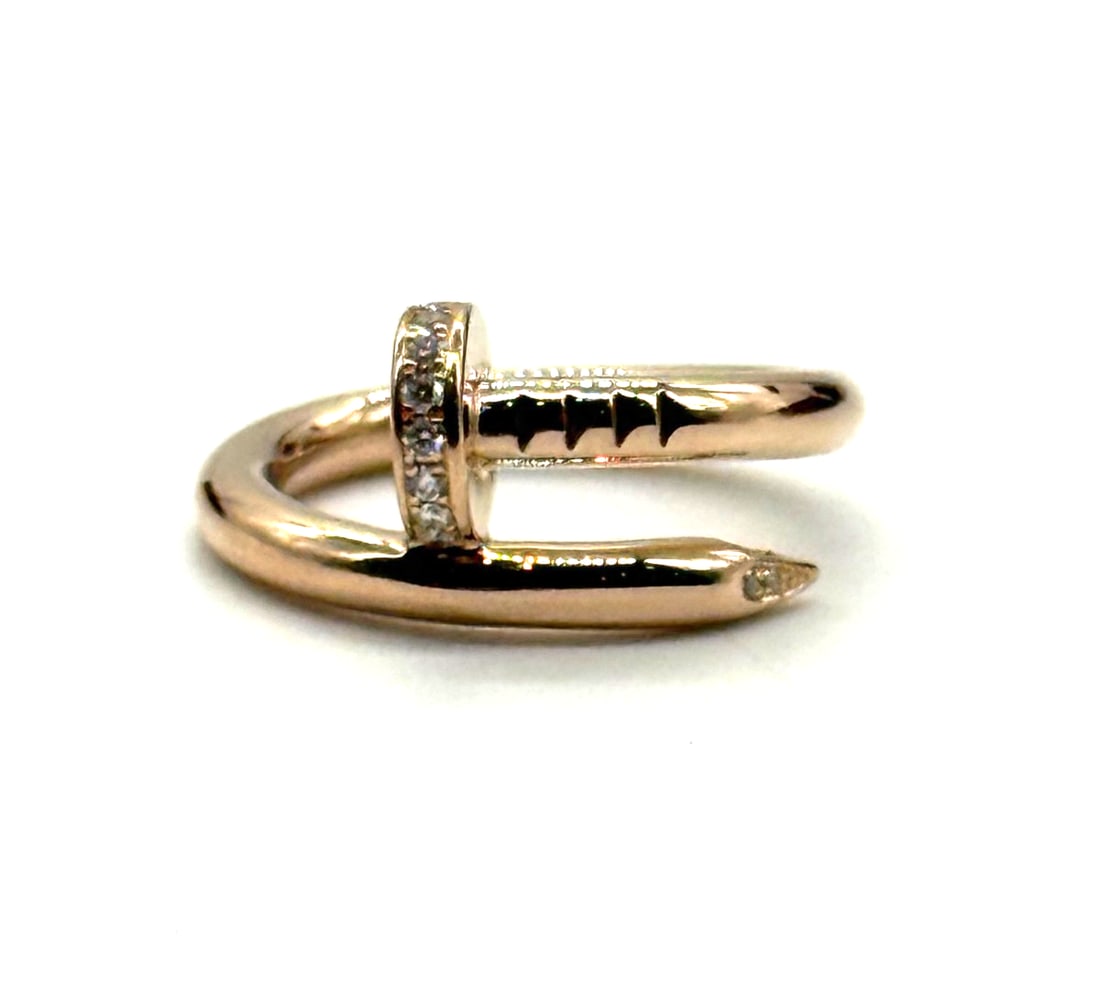 Cartier Juste Un Clou Ring 18K Rose Gold with Diamonds: The Cartier Juste Un Clou Ring in 18K Rose Gold with Diamonds is a stunning piece of fine jewelry that exudes elegance and sophistication. Crafted with natural pink color and white/colorless diamonds