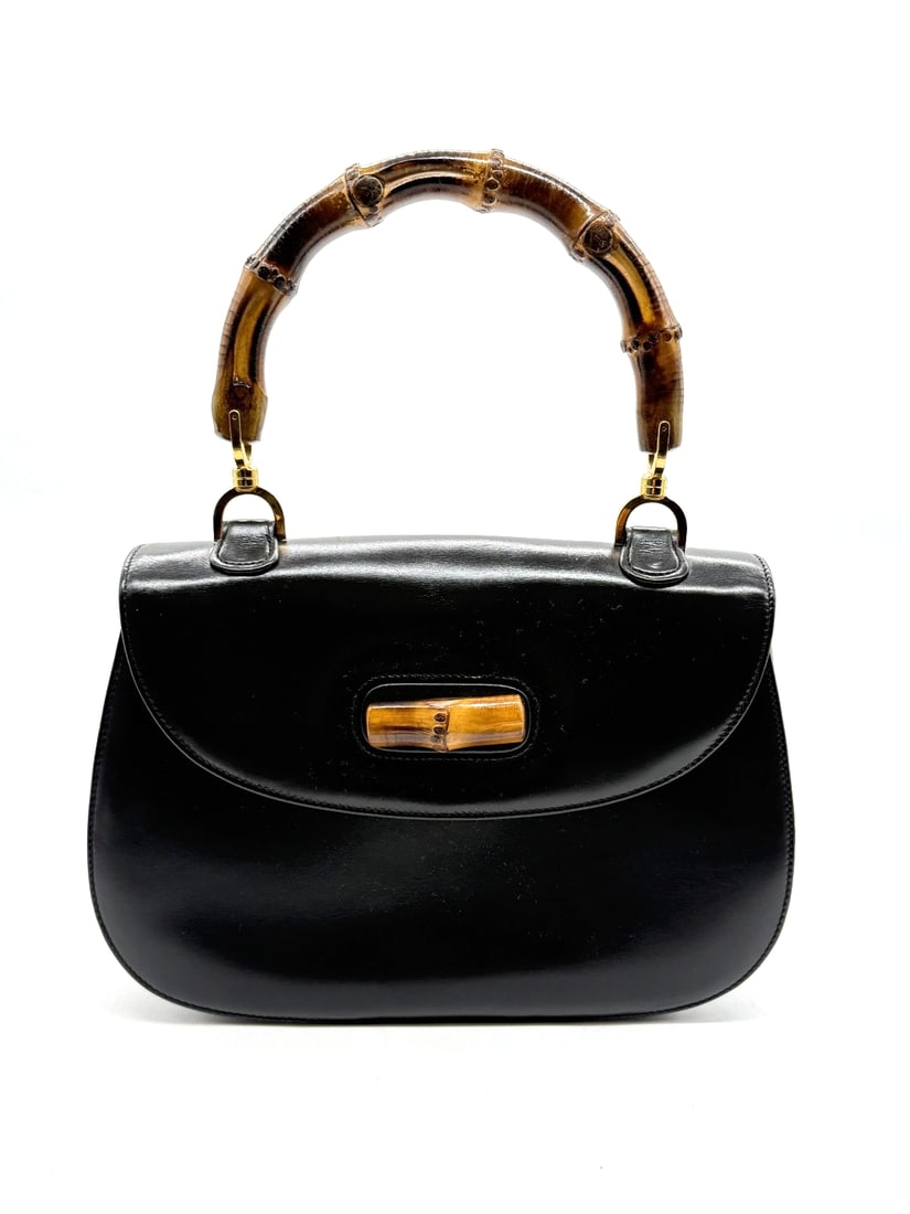 Gucci Vintage Bamboo Bag: The Gucci Vintage Bamboo Bag is a luxurious women's handbag from the iconic Gucci brand. Crafted from black leather with a black leather lining, this top handle bag exudes sophistication and elegance.