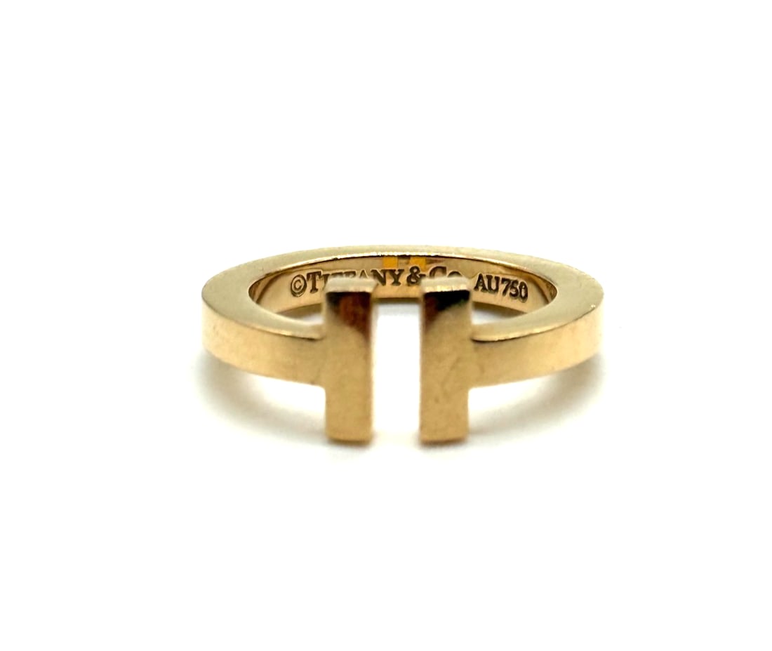 Tiffany & Co. T Square 18k Yellow Gold 2.5mm Wide Band Ring: This Tiffany & Co. T Square 18k Yellow Gold 2.5mm Wide Band Ring is a luxurious and stylish piece of fine jewelry. The square shape, 18k yellow gold metal, and 2.5mm band width give it a unique and so