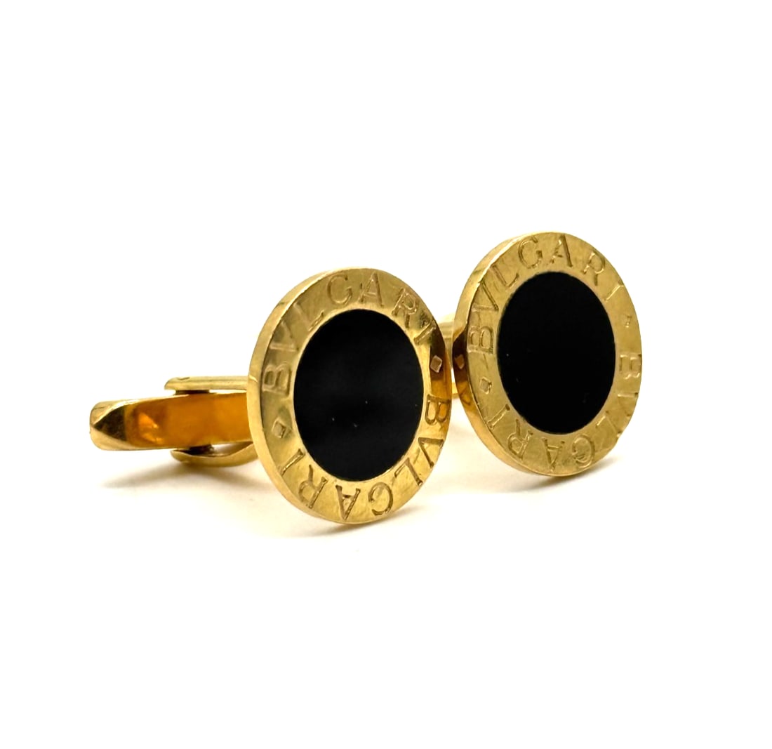 Bvlgari Vintage Cufflinks in 18K Yellow Gold: The Bvlgari Vintage Cufflinks in 18K Yellow Gold are a luxurious and stylish accessory for men. Made in Italy, these cufflinks feature a round black onyx stone set in 18K yellow gold. With excellent c