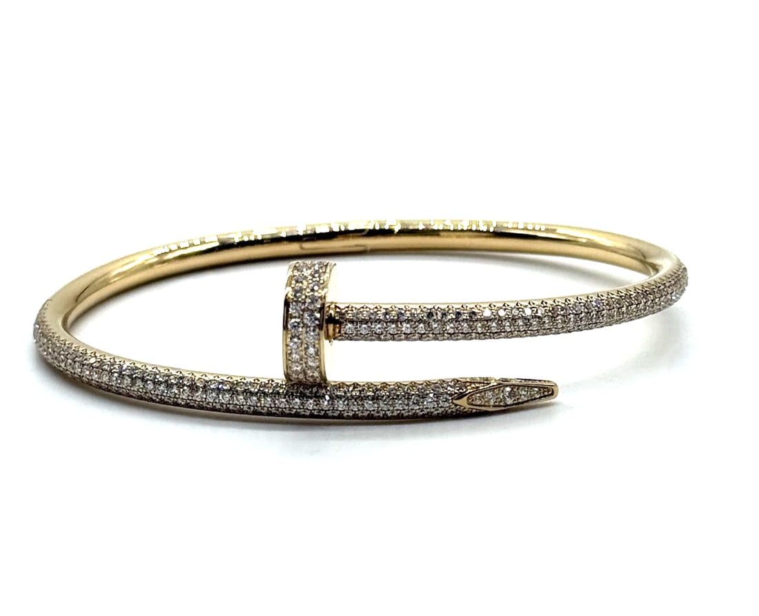 Cartier Juste un Clou Bracelet Pave Diamond Size 16 18kt Yellow Gold: The Cartier Juste un Clou Bracelet in 18kt yellow gold with pave diamond detailing is a luxurious and elegant piece of fine jewelry. Featuring a round, natural white/colorless diamond as the main ston