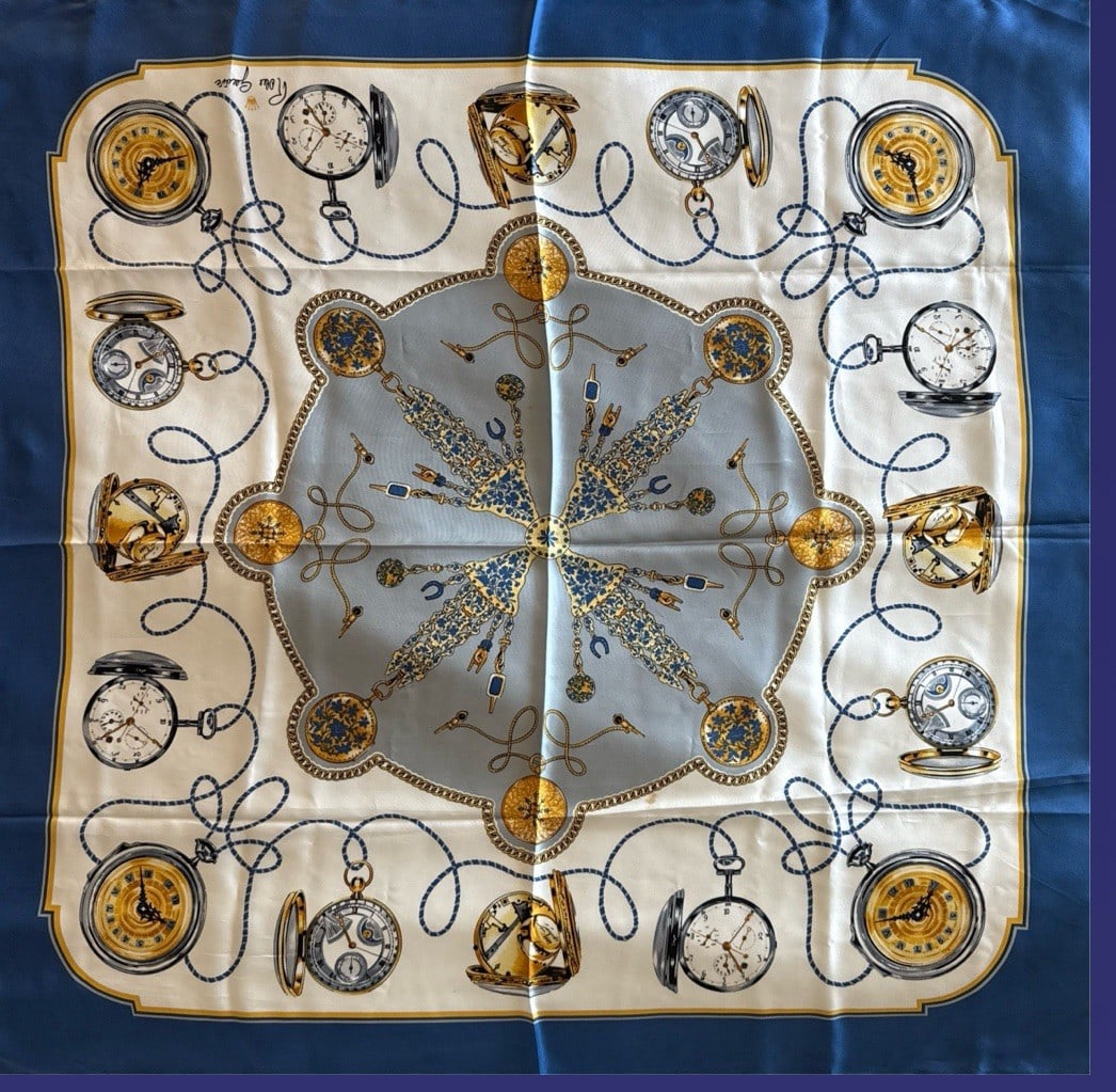 Vintage Authentic Rolex Geneve Silk Scarf Navy Gold Pocket Watches 33" x 35": The Vintage Authentic Rolex Genéve Silk Scarf features a navy blue color with gold accents, showcasing a unique pattern of pocket watches. Hand-sewn hems add a touch of craftsmanship to this luxuriou