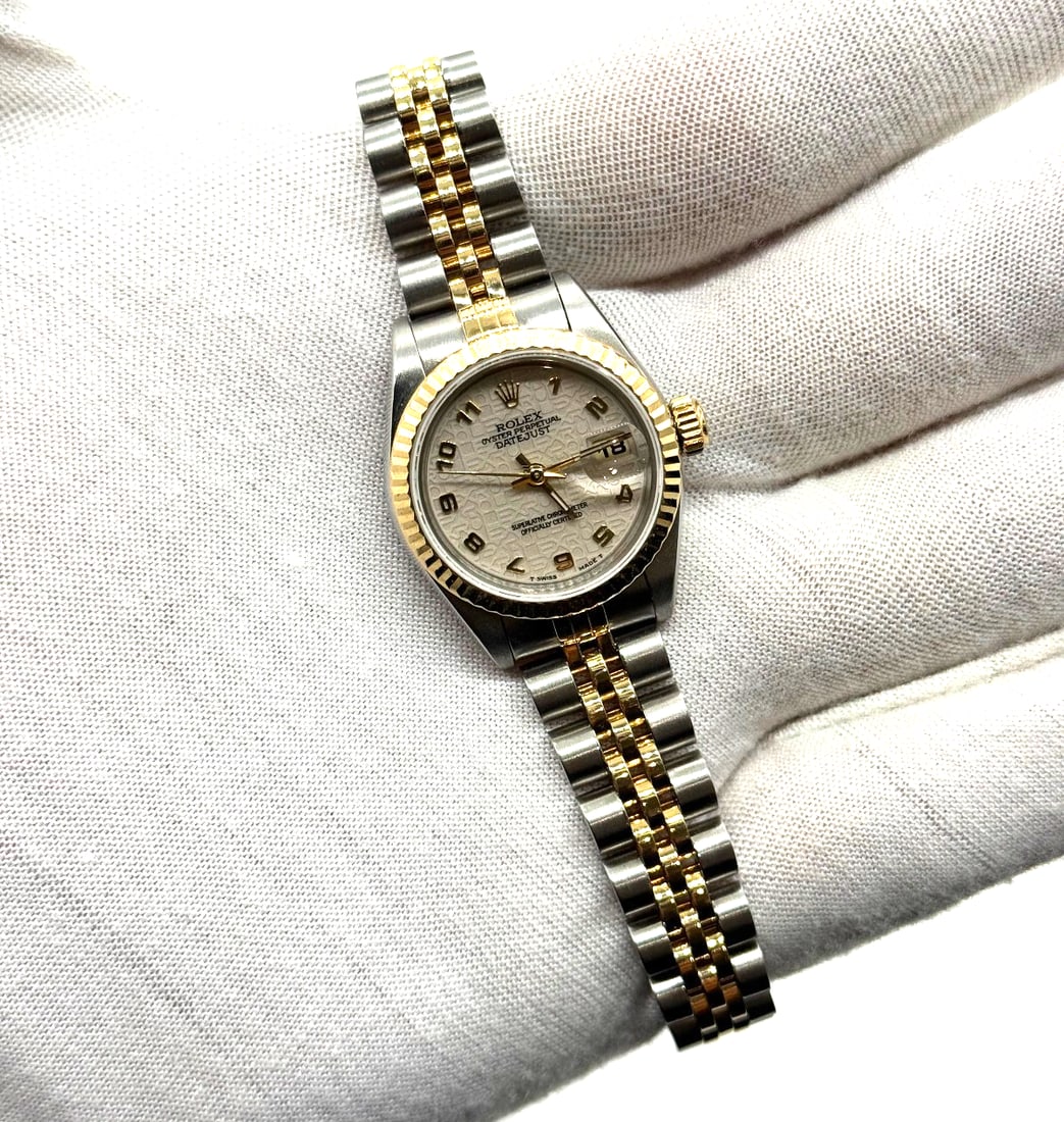 Rolex Lady Datejust 26mm 18kt Gold & Stainless Steel Watch 69173 "Computer Dial': The Rolex Lady Datejust 26mm 18kt Gold & Stainless Steel Watch 69173 is a luxurious and classic timepiece designed specifically for women. This wristwatch features a white dial with a date indicator,