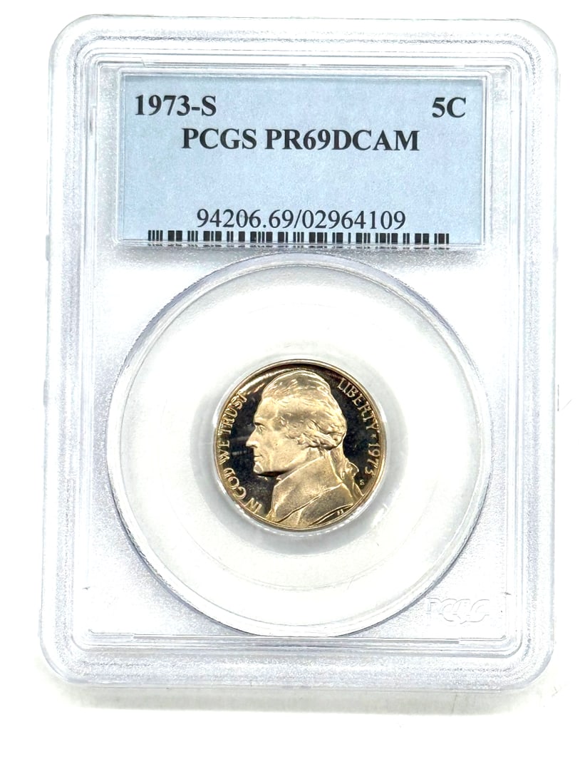 1973-S Jefferson Nickel - Proof, PR69 Deep Cameo (DCAM), graded by PCGS: The 1973-S Jefferson Nickel in PR69 Deep Cameo (DCAM) grade, certified by PCGS, is a highly sought-after coin for collectors. This US minted nickel features a proof strike type, making it a shiny and