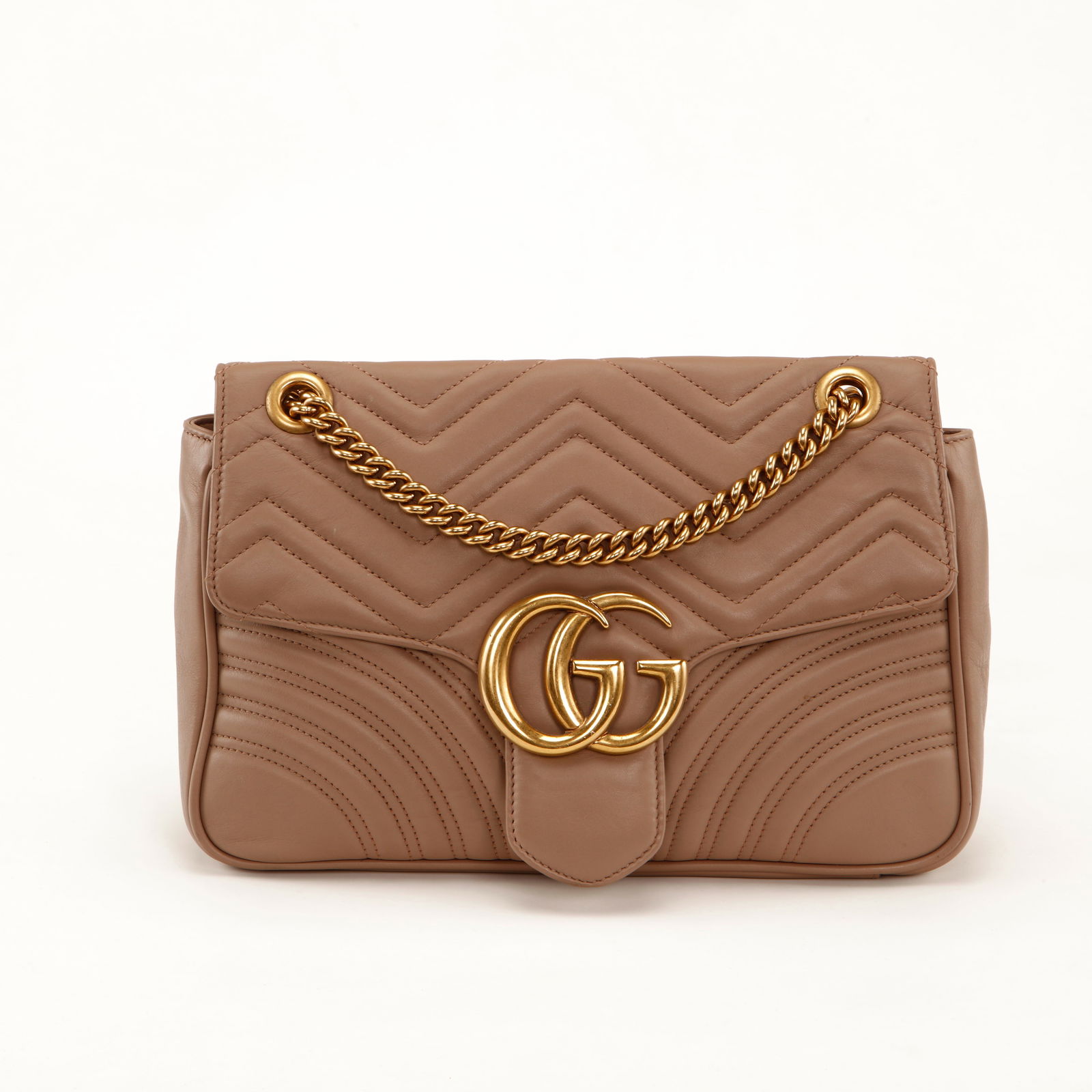 Gucci GG Marmont Matelassé Leather Shoulder Bag – Nude Beige with Gold Hardware: Elegant and timeless, this Gucci GG Marmont shoulder bag is crafted in soft nude beige matelassé leather featuring the iconic chevron quilting with curved stitching detail. The front is adorned with