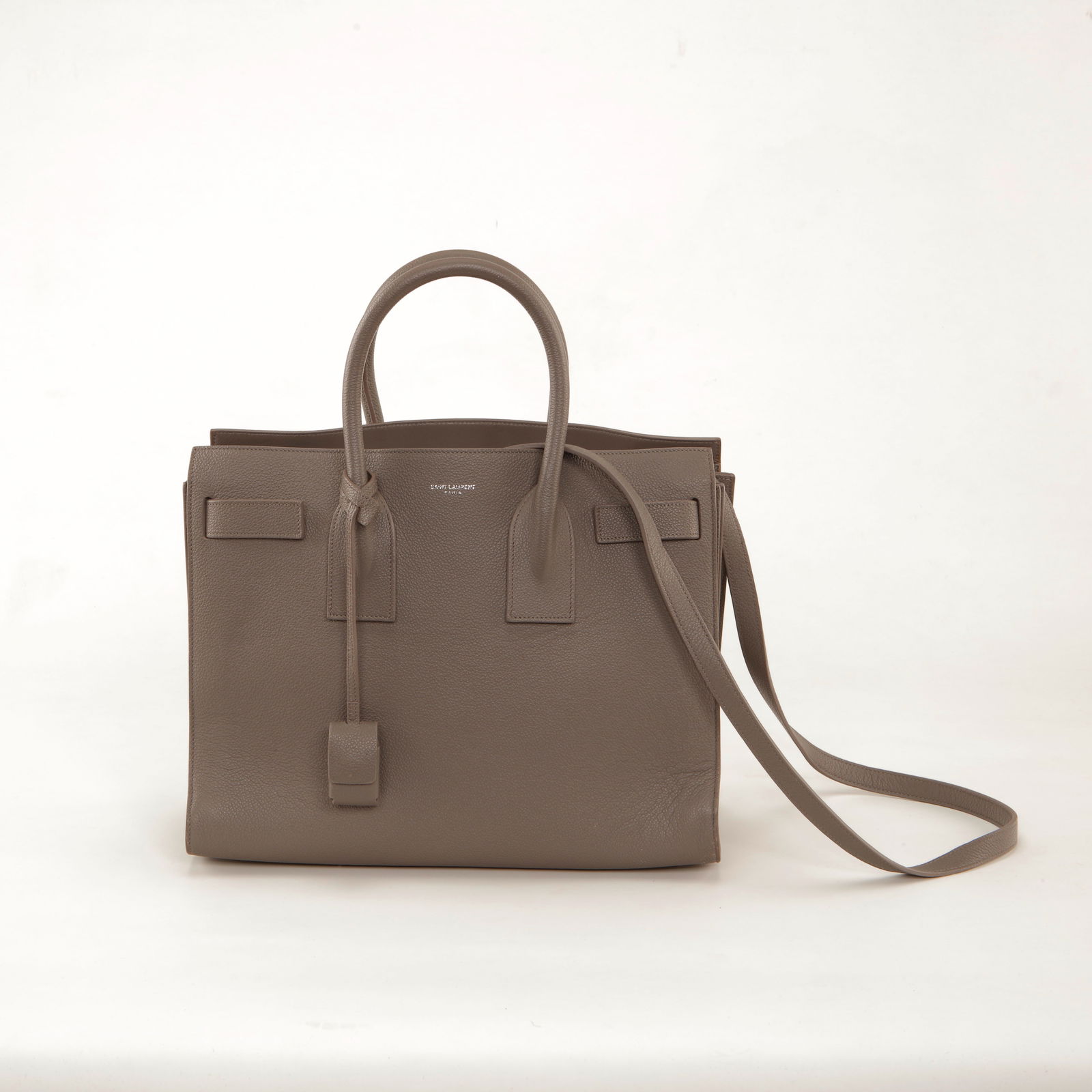 Saint Laurent Taupe Grained Leather Sac de Jour Tote: Saint Laurent Sac de Jour tote crafted in taupe grained leather featuring structured top handles, signature belted side tabs, and a detachable shoulder strap. The minimalist silhouette is finished wit