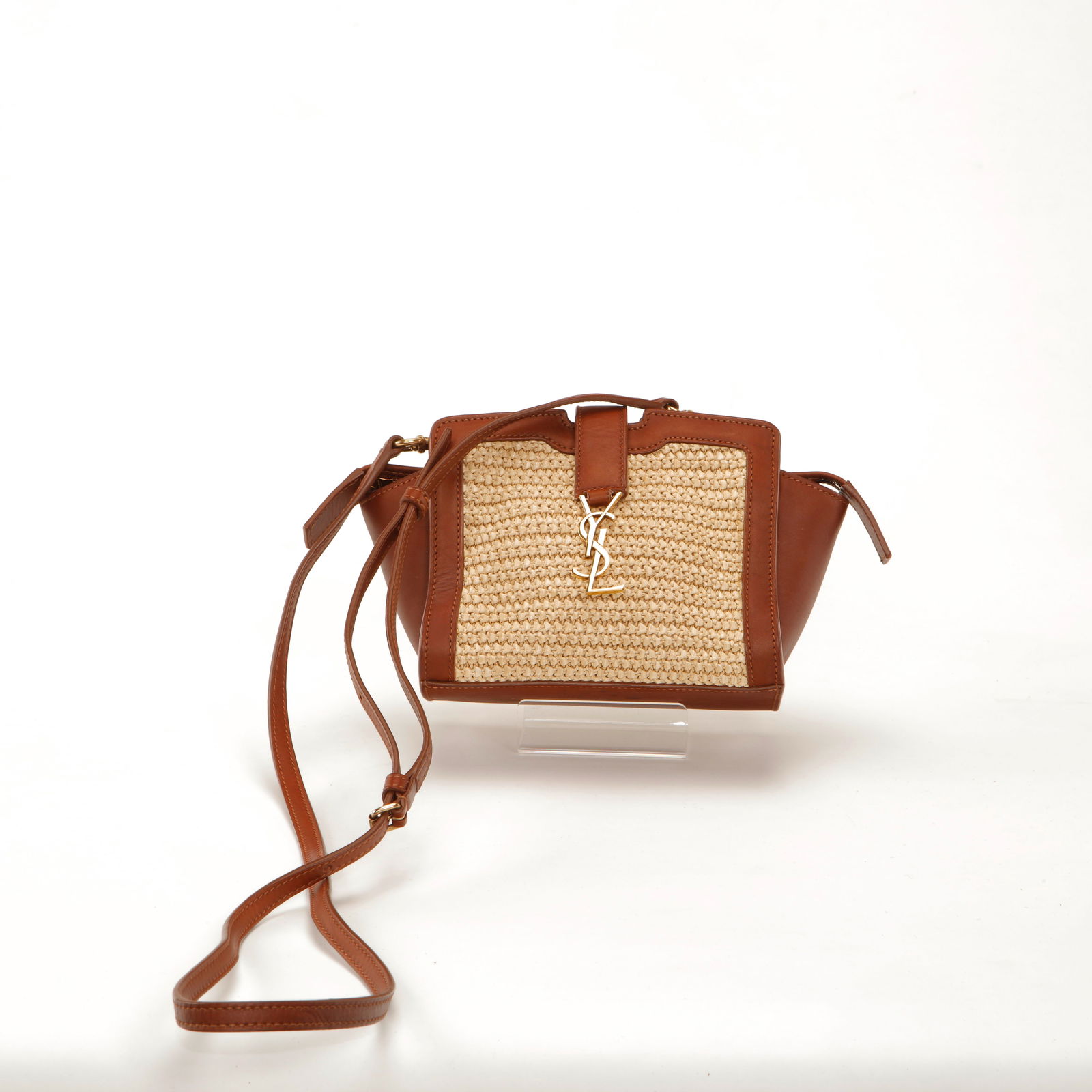 Saint Laurent Brown Leather & Raffia Monogram Mini Tote: Saint Laurent mini tote crafted in natural woven raffia with smooth brown leather trim and gold-tone YSL monogram hardware. Features structured top handles, side gussets, and a detachable shoulder str