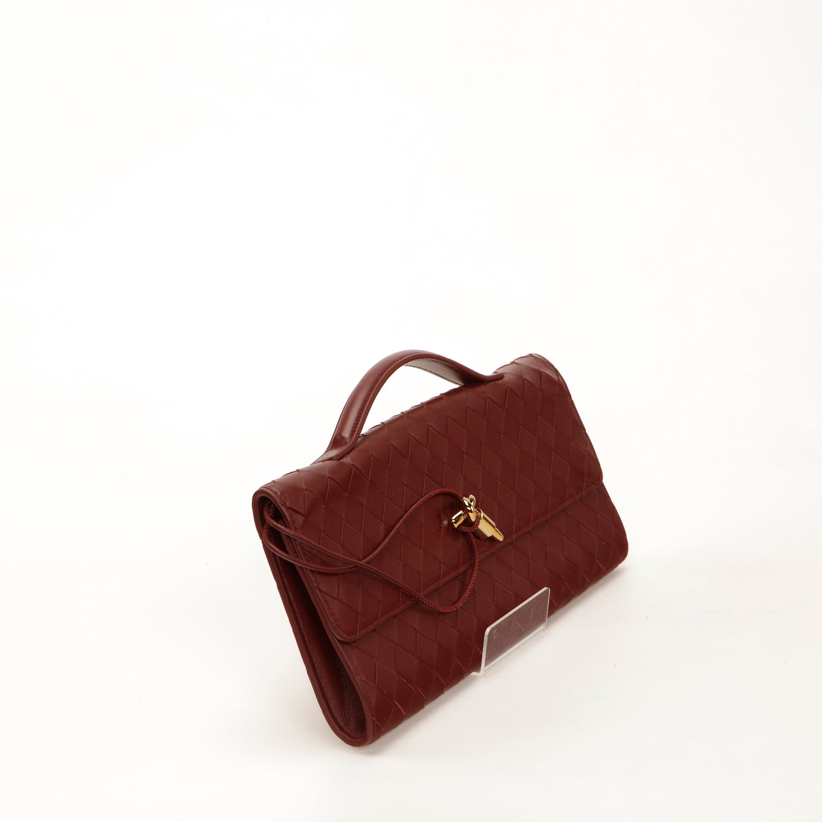 Bottega Veneta Brown Intrecciato Leather Clutch: Bottega Veneta clutch crafted in rich brown intrecciato woven leather featuring a structured flap closure and signature knot detail accent. Designed with a slim silhouette and refined craftsmanship, t