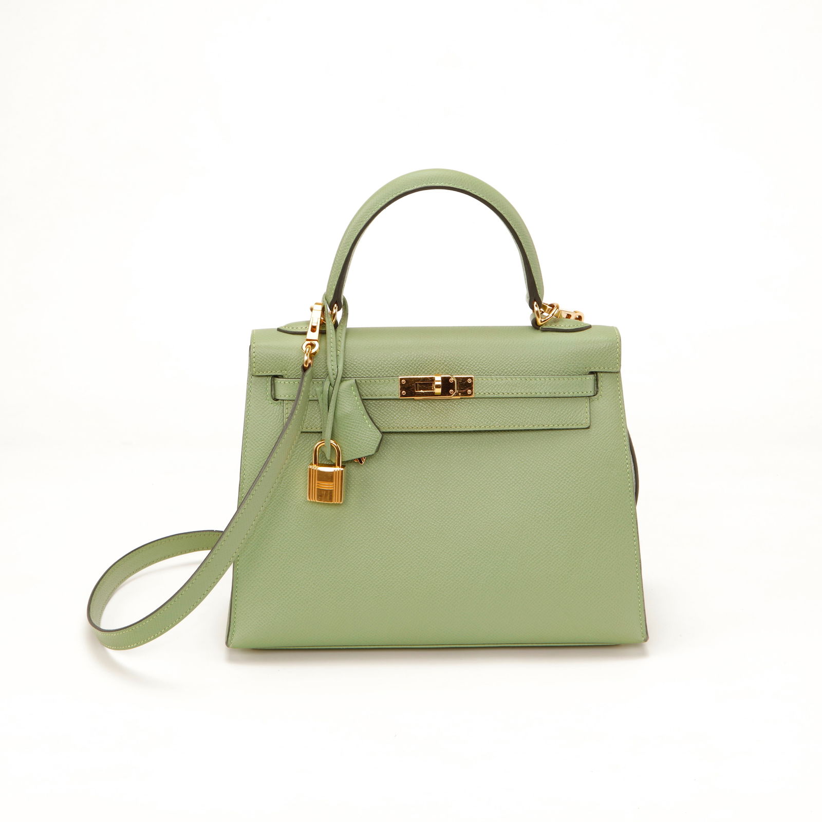 Hermès Kelly 25 Sellier Vert Anis Epsom Leather with Gold Hardware: Hermès Kelly 25 Sellier crafted in structured Vert Anis Epsom leather featuring gold-tone hardware, signature turn-lock closure, clochette, and padlock. Designed with a single top handle and removabl