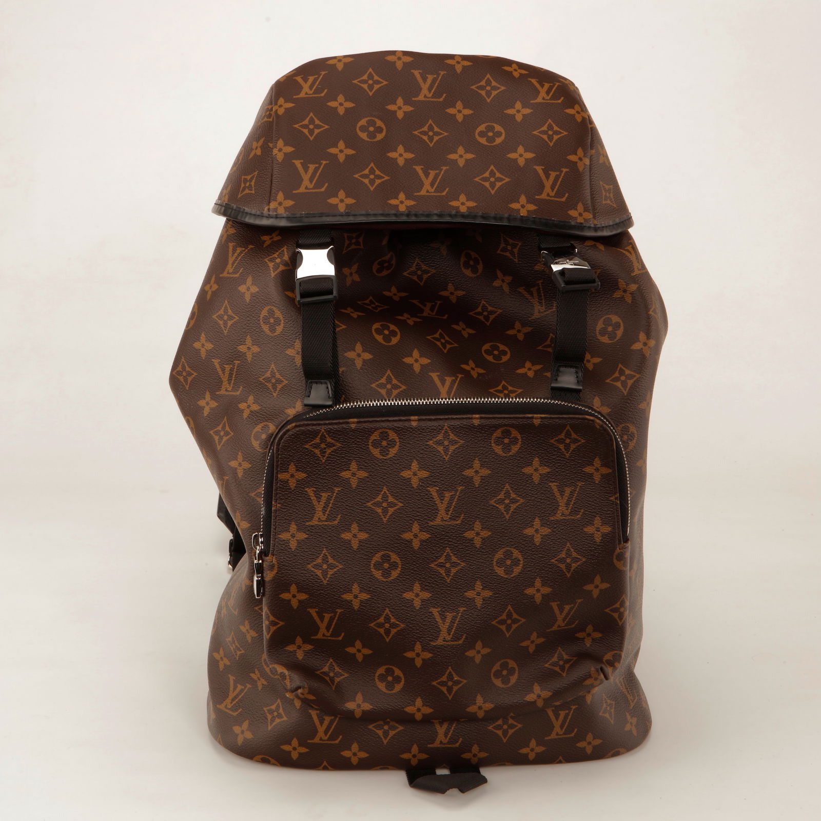 Louis Vuitton Monogram Macassar Christopher PM Backpack: Authentic Louis Vuitton Christopher PM Backpack crafted in iconic Monogram canvas with black leather trim and silver-tone hardware. This modern yet rugged design features a spacious main compartment w