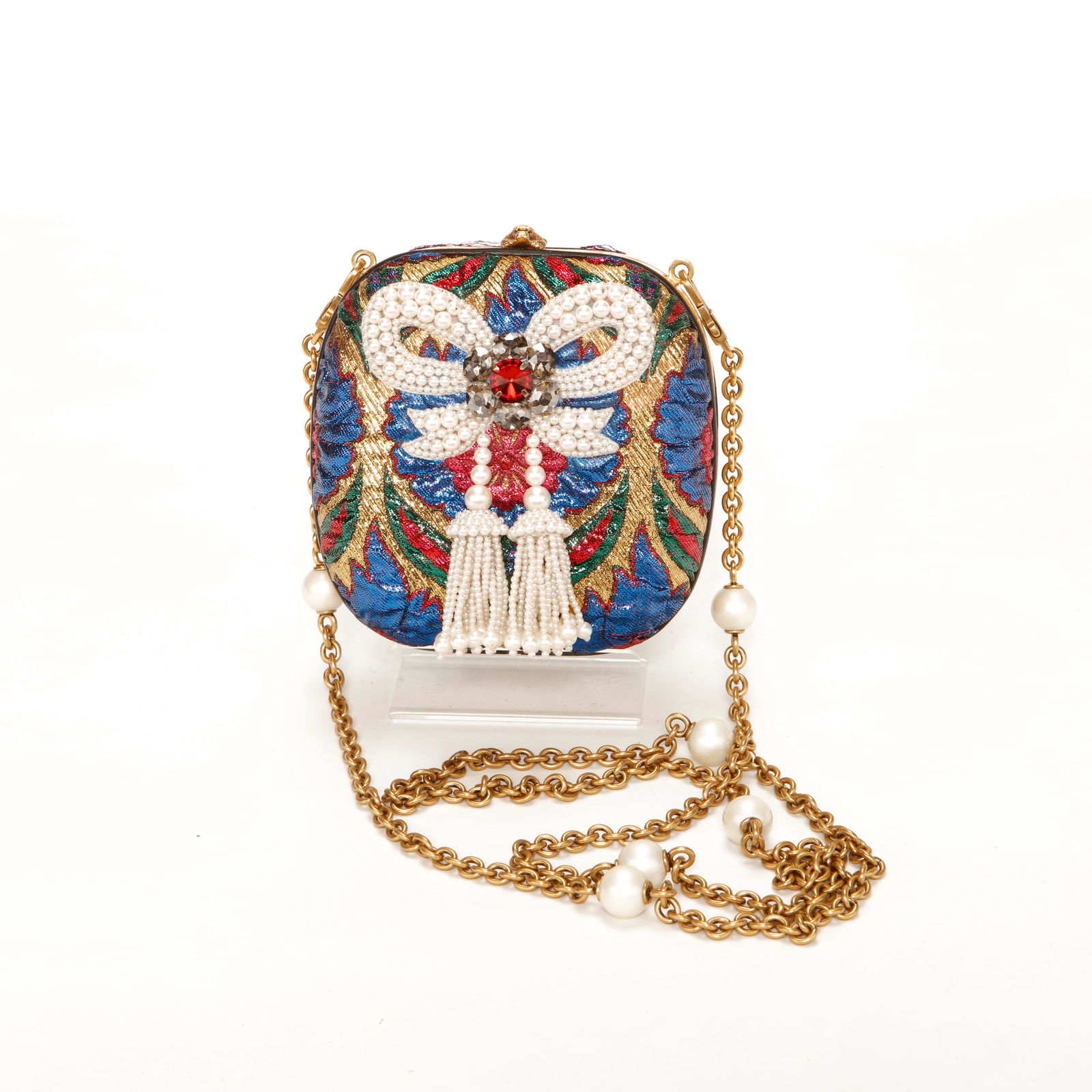 Gucci Embellished Brocade Minaudière with Pearl & Crystal Detail: Authentic Gucci structured minaudière crafted in multicolor brocade with intricate pearl and crystal embellishment. The front features a dramatic jeweled motif with a central red crystal accent and