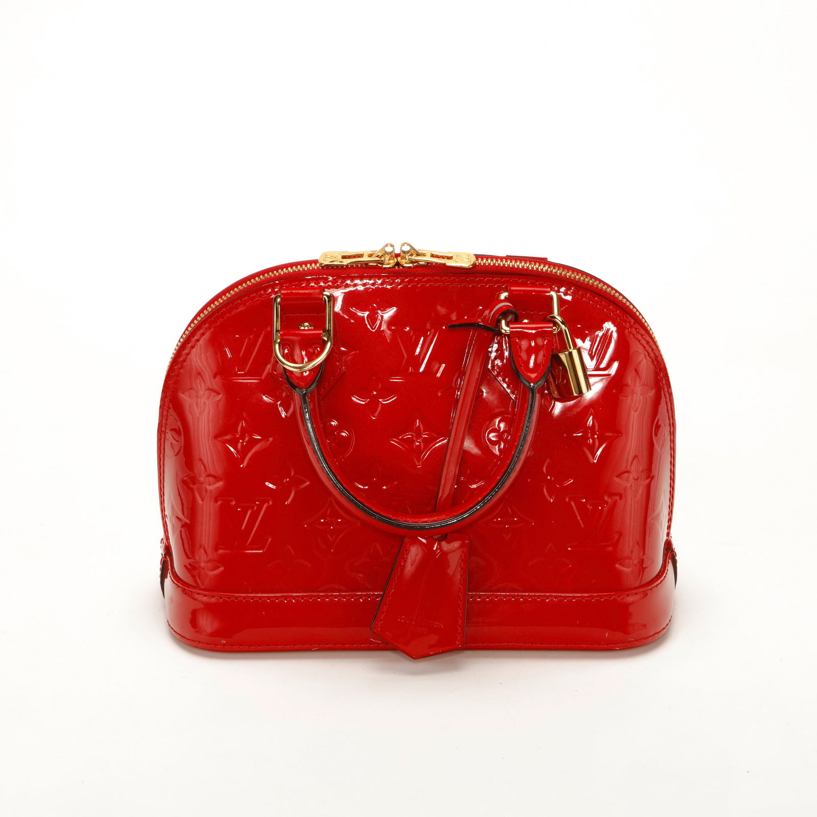 Louis Vuitton Alma BB – Red Monogram Vernis: Authentic Louis Vuitton Alma BB crafted in glossy red Monogram Vernis patent leather with gold-tone hardware. This iconic dome-shaped silhouette features double rolled top handles, dual zip closure,