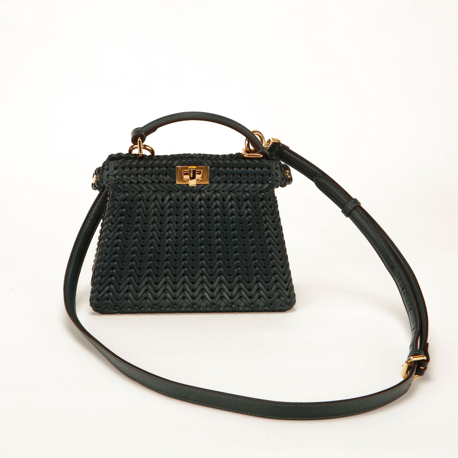 Fendi Peekaboo Mini – Green Woven Leather: Authentic Fendi Peekaboo Mini crafted in intricately woven green leather with gold-tone hardware. This structured yet soft silhouette features the signature Peekaboo twist-lock closure, single top han