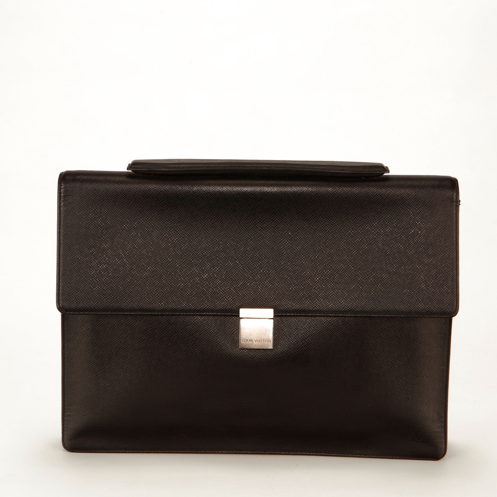 Louis Vuitton Taiga Leather Briefcase – Brown: Authentic Louis Vuitton briefcase crafted in textured Taiga leather in deep brown. This structured professional silhouette features a top handle, flap closure with silver-tone push-lock hardware