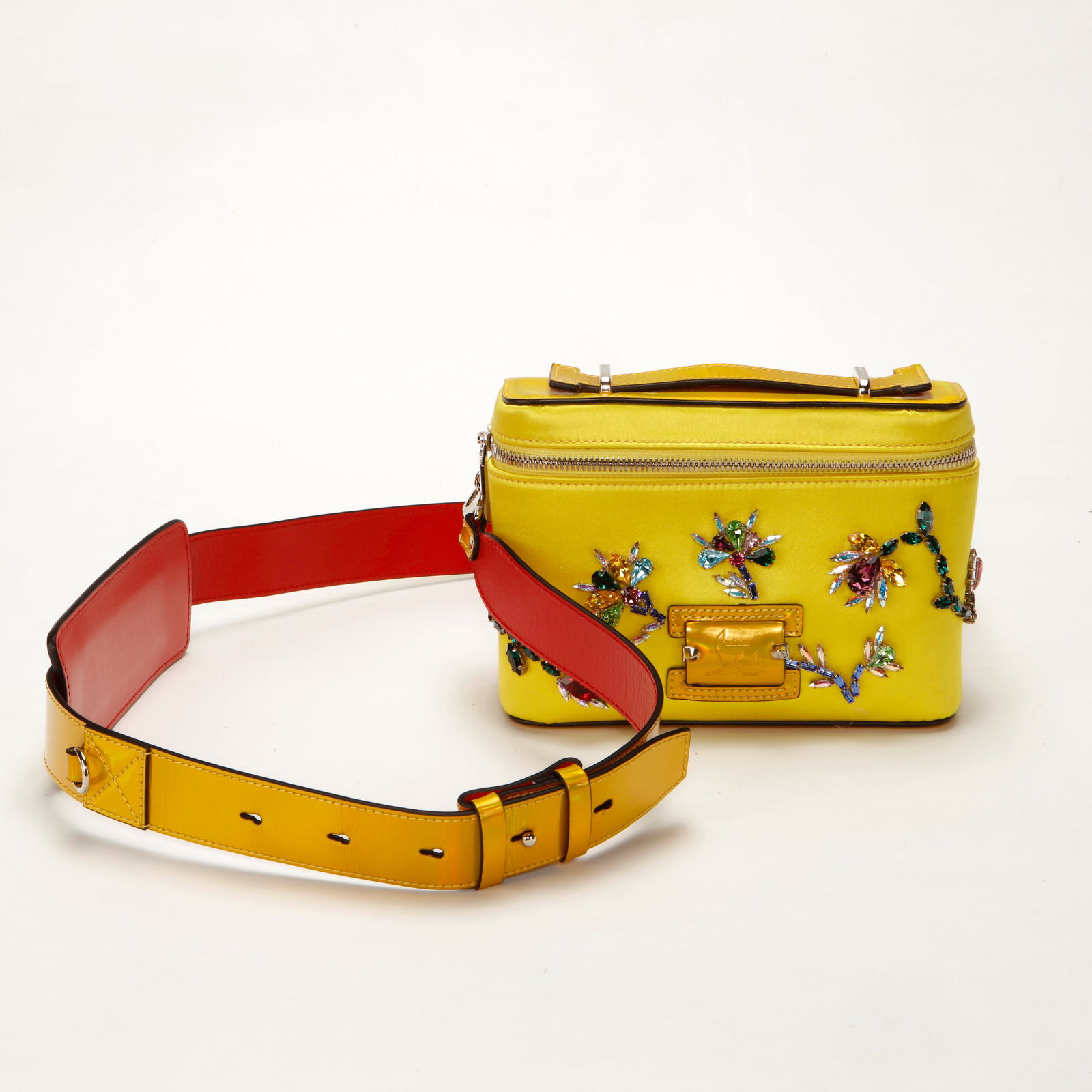 Christian Louboutin Embellished Satin Belt Bag Yellow: Christian Louboutin structured belt bag crafted in vibrant yellow satin, adorned with multicolor crystal and jewel floral embellishments. Features a top zip closure, signature engraved front plaque, s