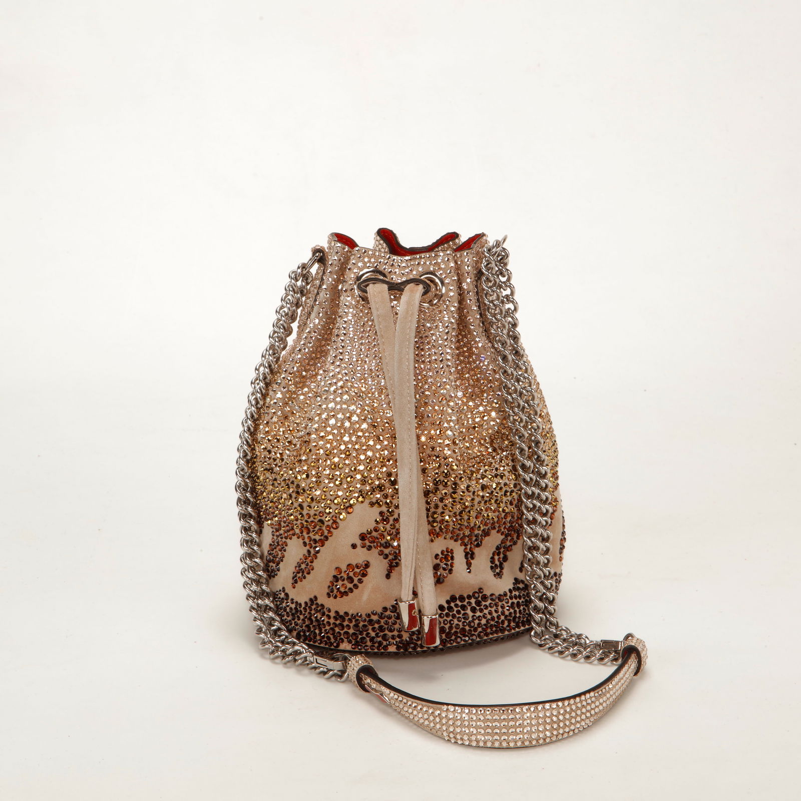 Christian Louboutin Marie Jane Mini Strass Bucket Bag: Christian Louboutin Marie Jane Mini bucket bag crafted in nude suede fully embellished with gradient strass crystals in warm champagne tones. Features a drawstring closure, silver-tone chain shoulder