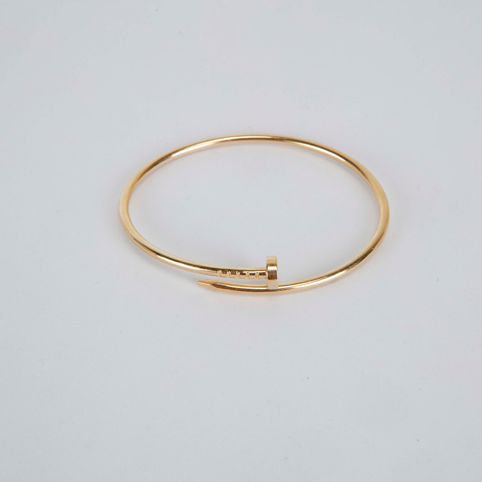 Cartier Juste un Clou 18K Yellow Gold Small Bracelet Size 17: Cartier Juste un Clou small bracelet size 17 crafted in 18K yellow gold, designed in the iconic nail silhouette that wraps seamlessly around the wrist. Featuring the signature sculpted head and ridged