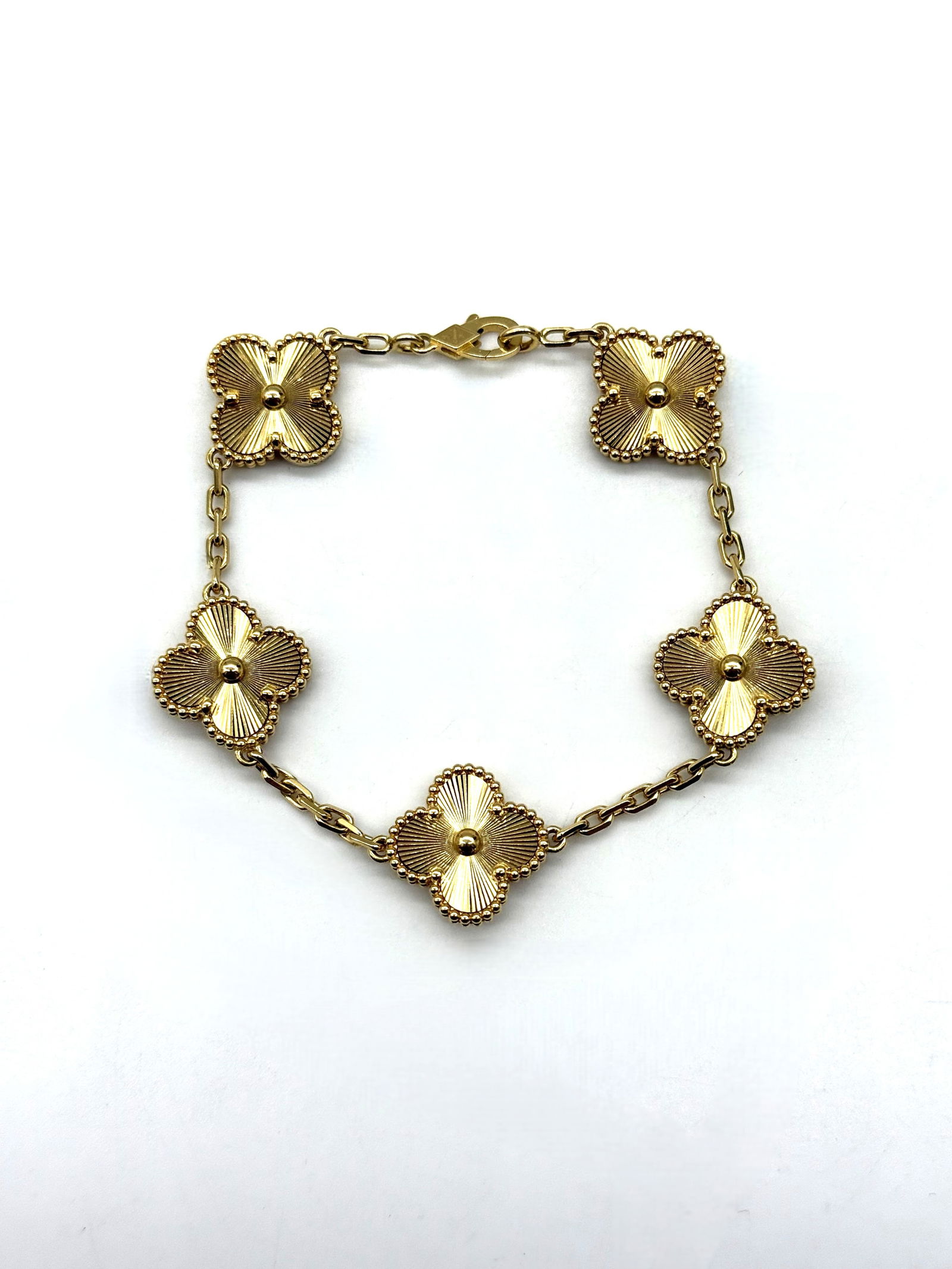 Van Cleef & Arpels Vintage Alhambra Guilloché Bracelet 18K Yellow Gold 5 Motifs: Authentic Van Cleef & Arpels Vintage Alhambra bracelet crafted in 18K yellow gold. The bracelet features five iconic clover motifs with radiant guilloché engraving, a signature design of the Maison s