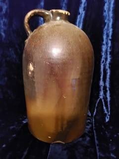 J. Freyhan & Co. Stoneware Jug with Handle: Stoneware jug marked with ‘J. Freyhan & Co.’ in molded relief. Features a single handle and glazed surface. Significant wear is present, including shallow chips near the rim and base, and small cr