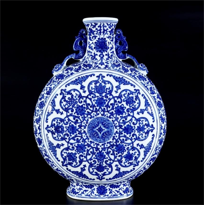 A blue and white entwined branch lotus pattern amphora held moon bottle made in the Qianlong year of: Qing Dynasty Qianlong year of the blue and white entwined branch lotus pattern amphora holding moon bottle Size: H:41cm Belly D:30cm (The Dimensions Of All Batches Are Manually Measured.If You Need Mo