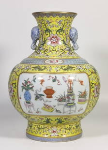 A yellow earth pattern window opening eight treasure elephant ear bottle made in the Qianlong era of: The Qing Dynasty Qianlong year made a yellow ground pattern window opening eight treasure elephant ear vase SIZE: H:28cm Belly D:20cm (The Dimensions Of All Batches Are Manually Measured.If You Need M