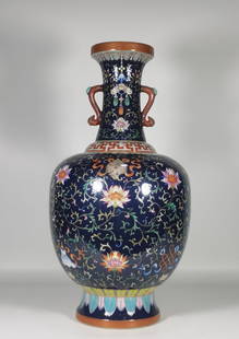 A Qing Dynasty Qianlong year enamel blue glaze entwined lotus eight treasure pattern ruyi ear bottle: Qing Dynasty Qianlong year enamel blue glaze entwined lotus eight treasure pattern ruyi ear bottle SIZE: H:41.5cm Mouth D:9.5cm Belly D:20cm Foot D:12.5cm (The Dimensions Of All Batches Are Manually M
